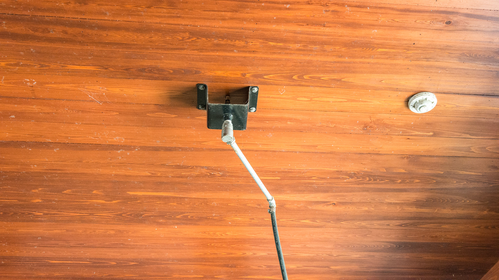 Details of the ceiling in a wash stall. Swivel water output and a fire detector all on a hardwood ceiling