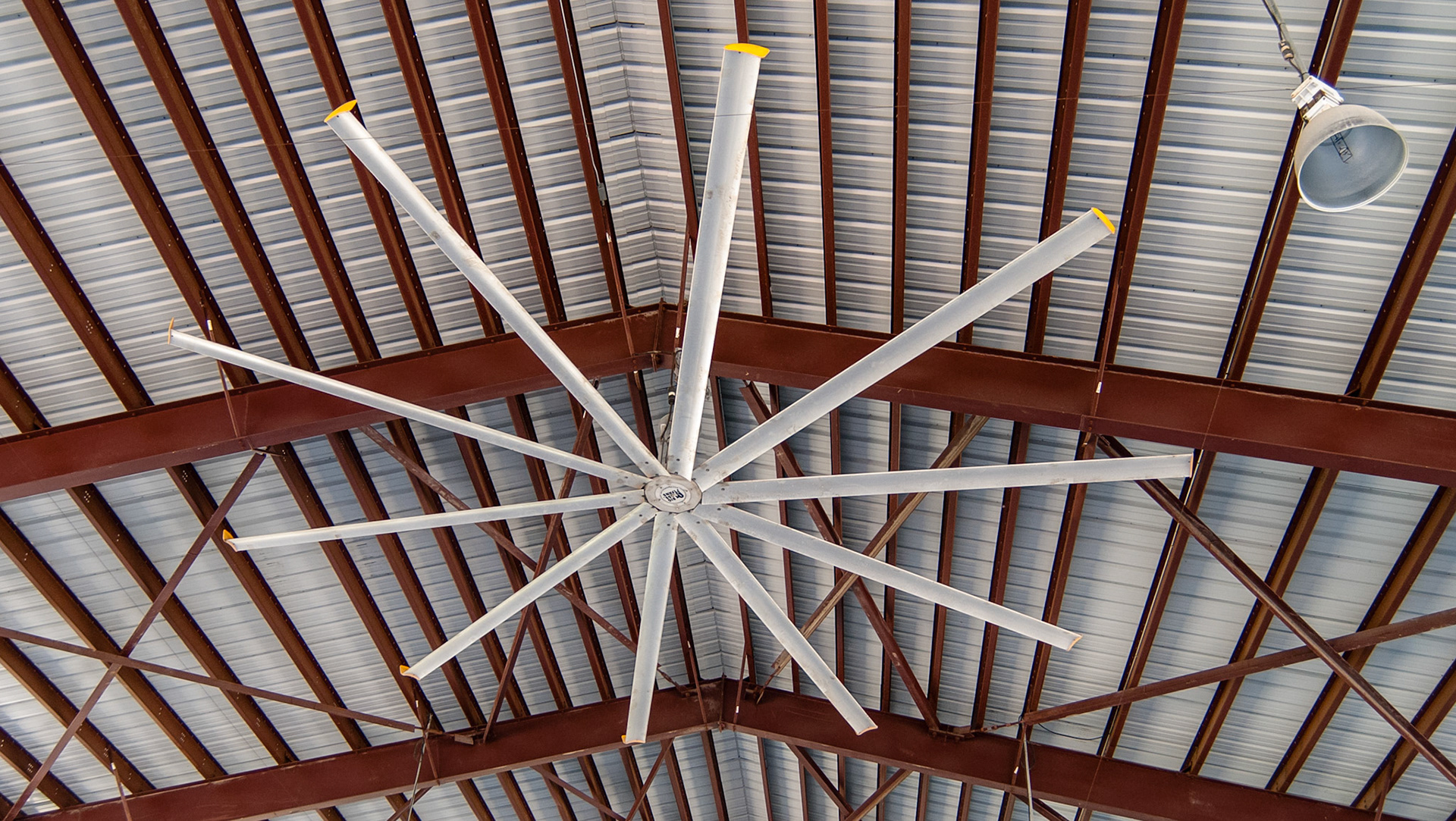3 of these very large ceiling fans cool the covered arena at this Florida assisted riding arena.