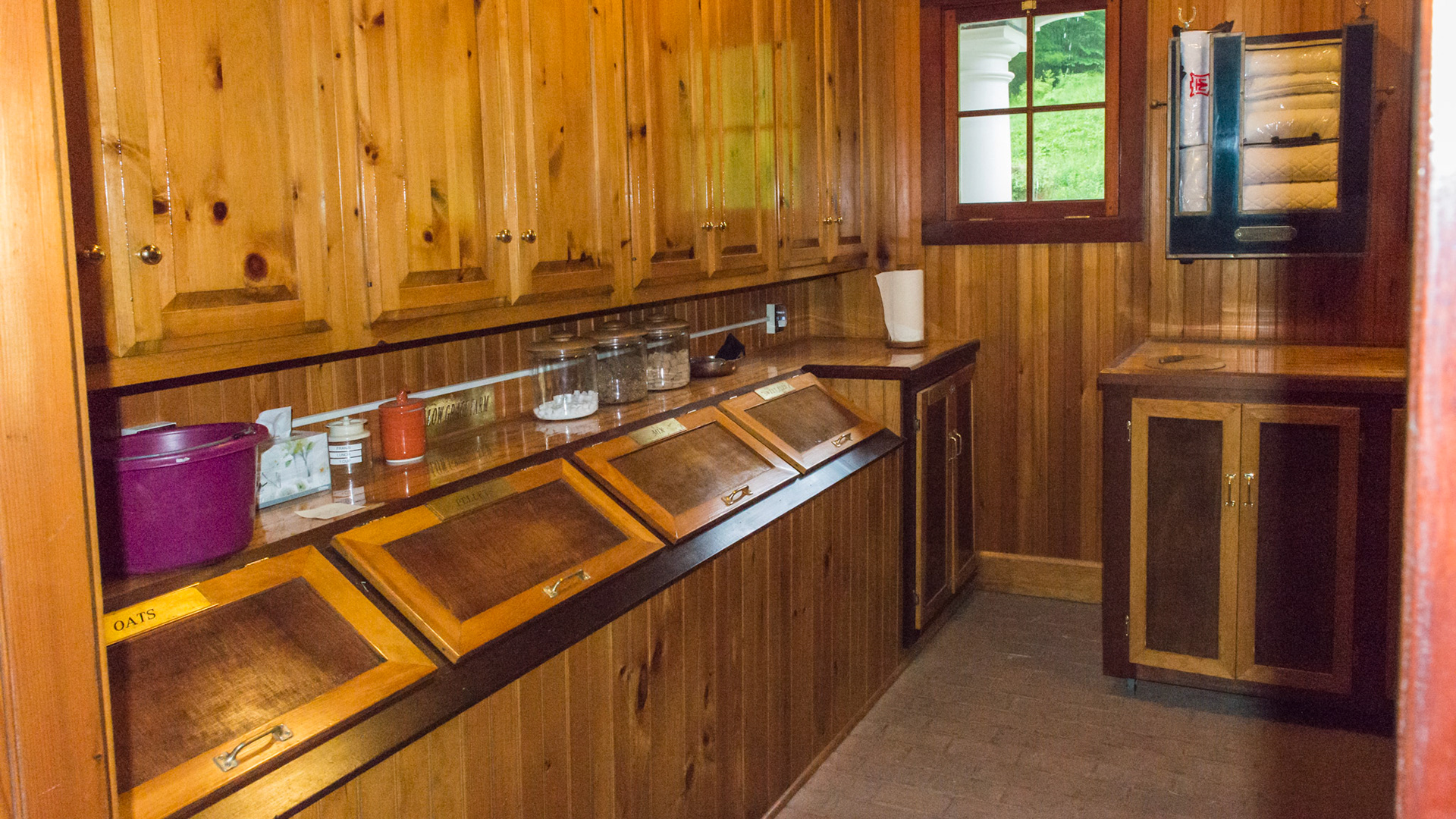 A beautiful and clean feed room.  Behind each door is a different type of feed.