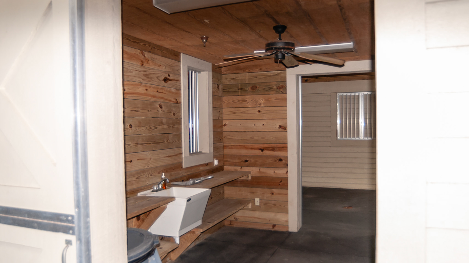 Multiple features in an abandoned horse farm being used for storage.