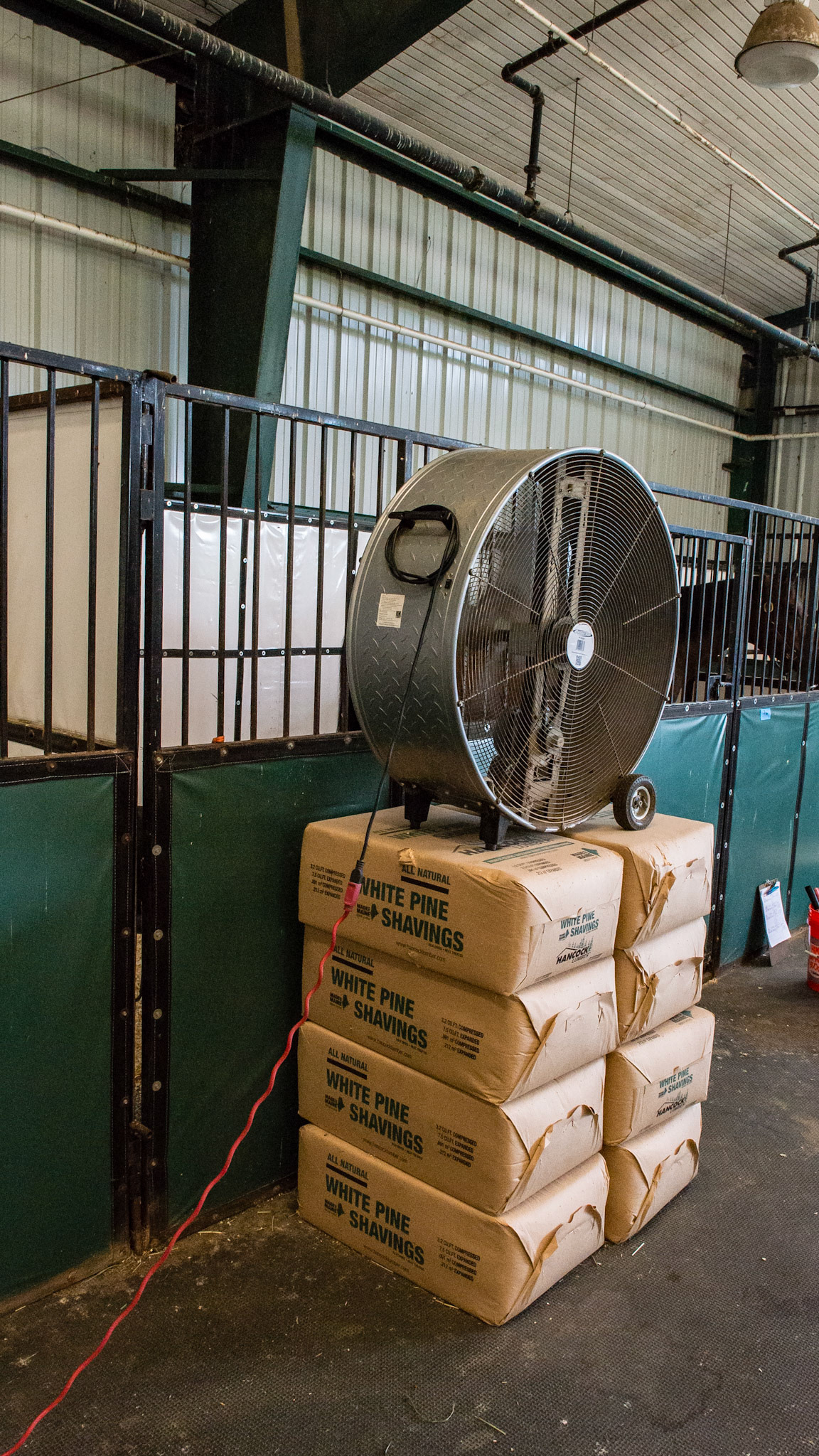 Every stall in this barn had this large fan in front of the stall raised on anything that would do the job.