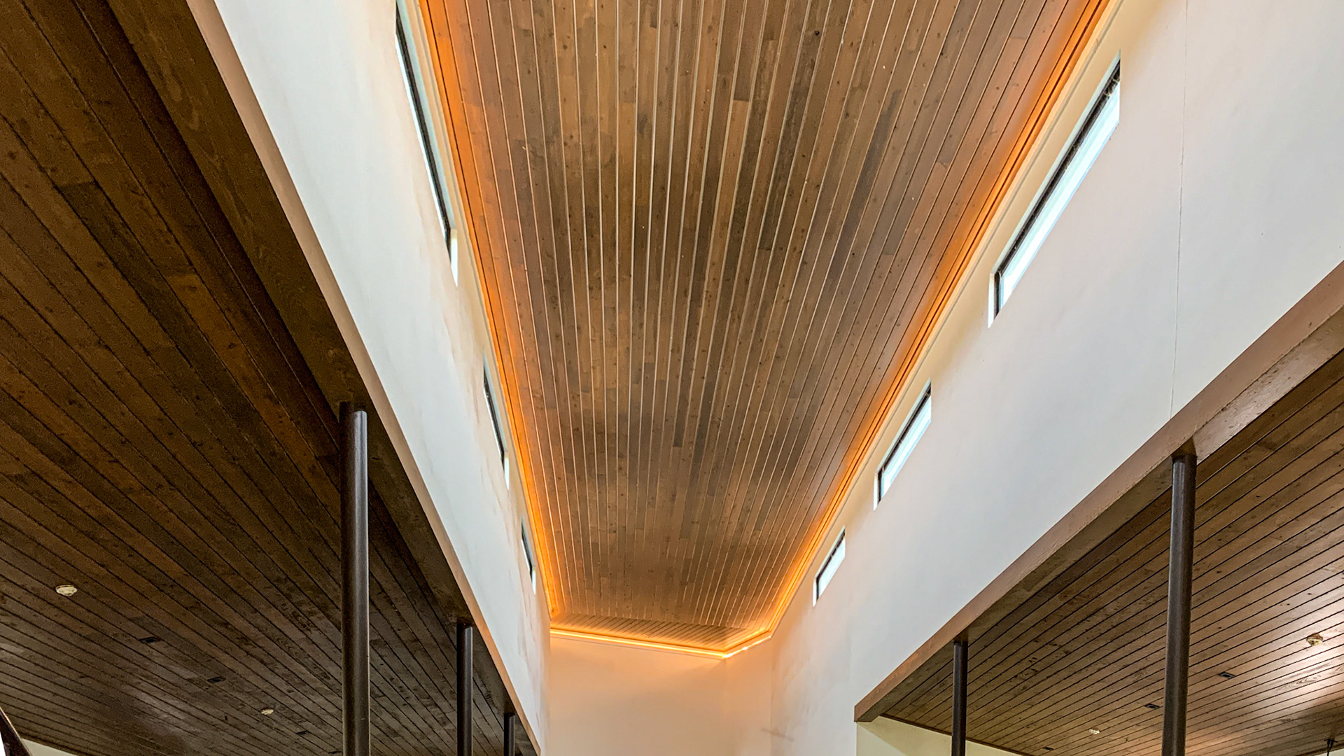 LED accent lightings lines the ceiling between the ceiling and the vertical walls that remain on during daylight.  I bet they look nice as night as well as adding light to inspect but not much to affect the sleep of the horses.