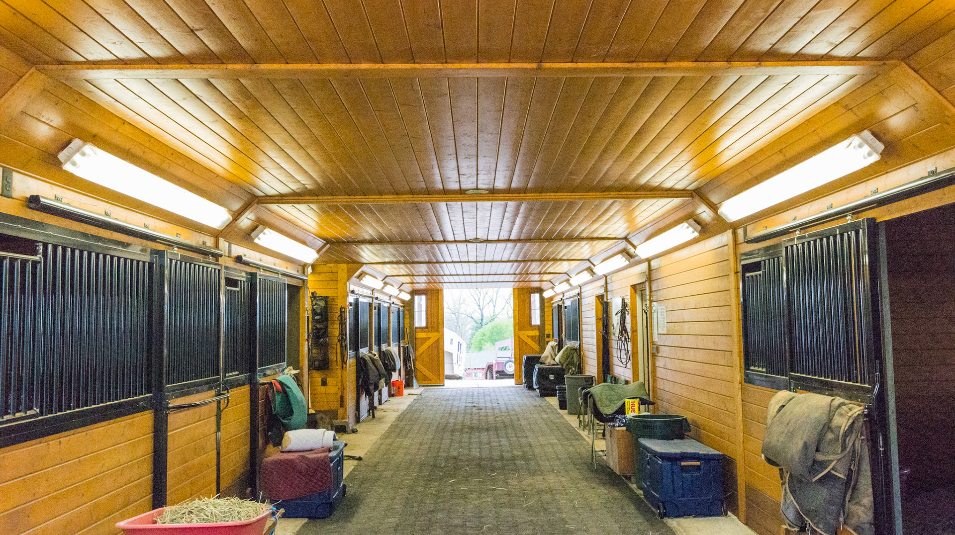 Fluorescent lights angled along the sides of the ceiling. Rubber brick flooring