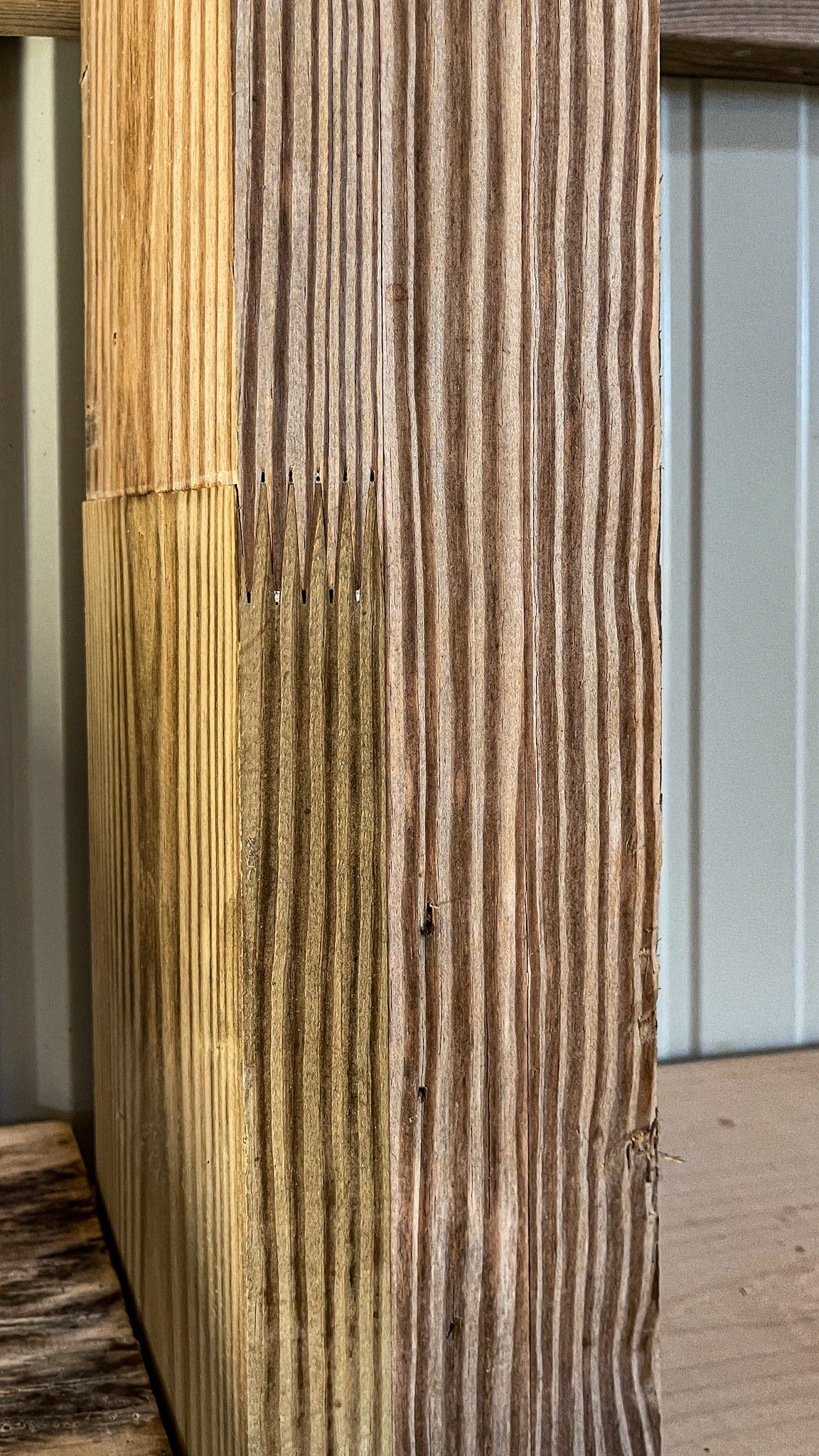 Laminated boards add strength to this vertical column. Note the saw-tooth joint.