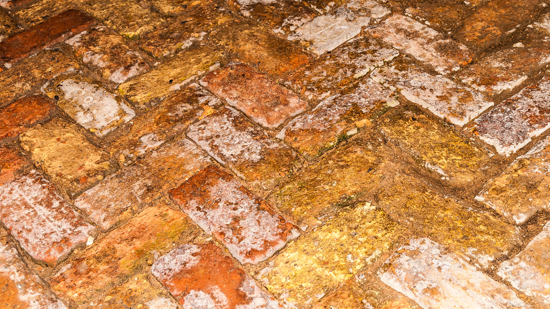 Hand laid brick in a herringbone pattern.