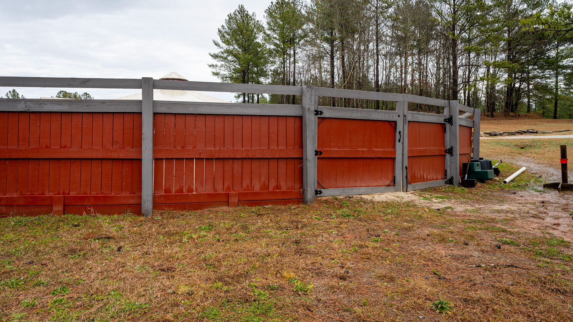 Various views of a round pen built into a hillside.