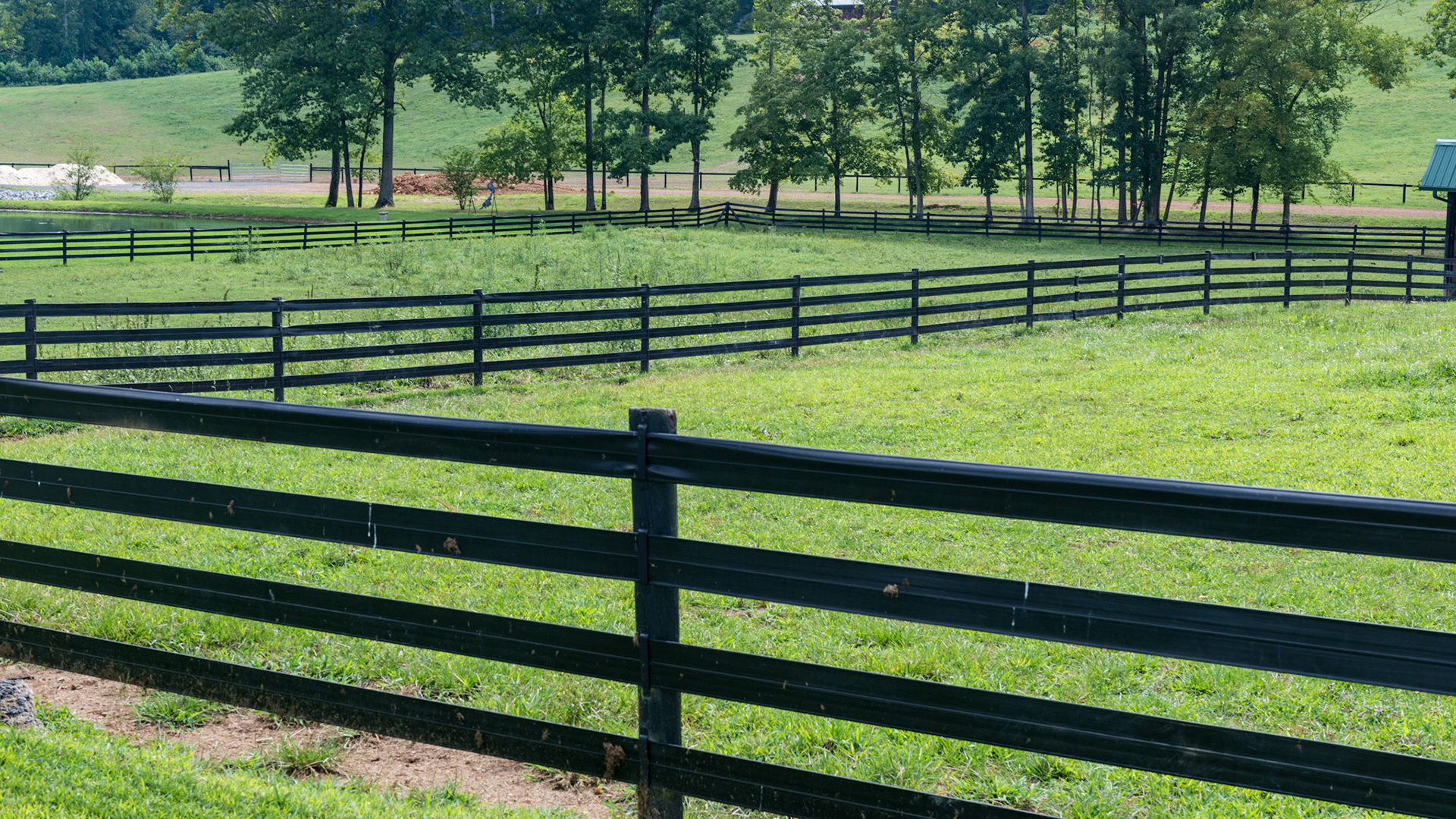 Black vinyl fencing with tensioners keeps this fence tight, though horses can stretch the bands and get parts of themselves trapped requiring 2 people to clear them. She said it had happened to 5 horses in the past month.