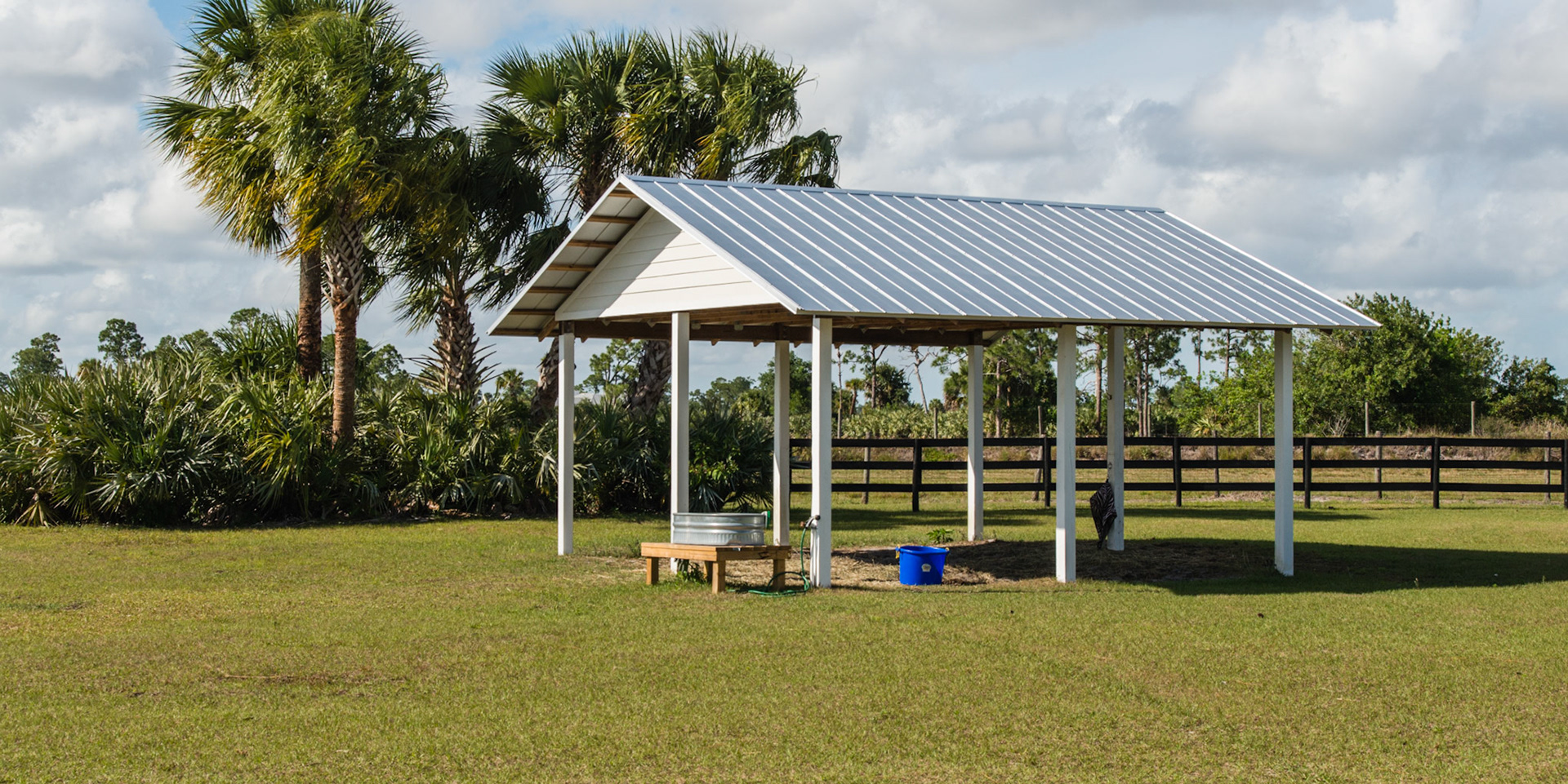 A simple shade shed in FL is different from a northern 3 sided shed.  This shed allows for any breeze to keep the horse cool while a sided shed protects the horse from wind.