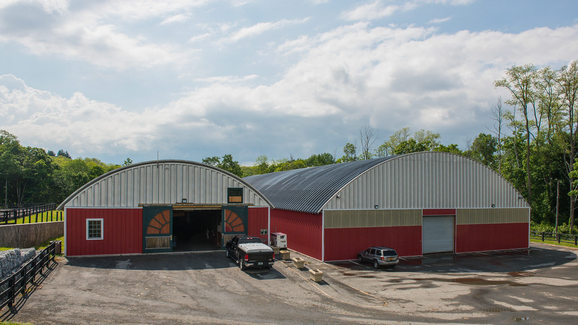 Quonset hut design for the roof of this barn and covered arena