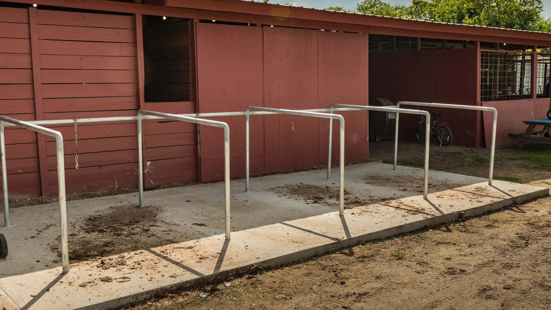 Grooming and tacking racks outside the barn.