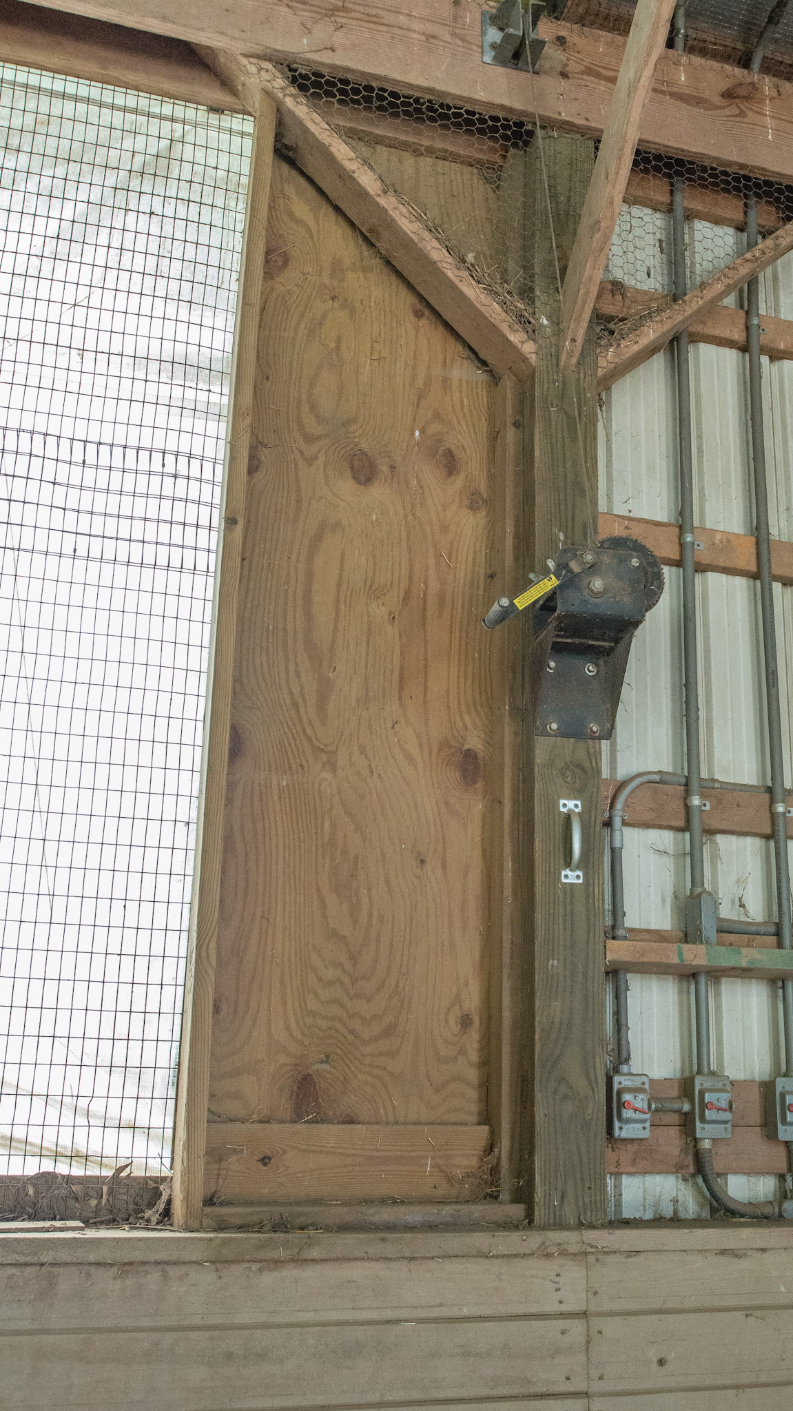 This plastic window covering runs the length of the barn and can be raised during good weather.  This is the mechanism to raise it.