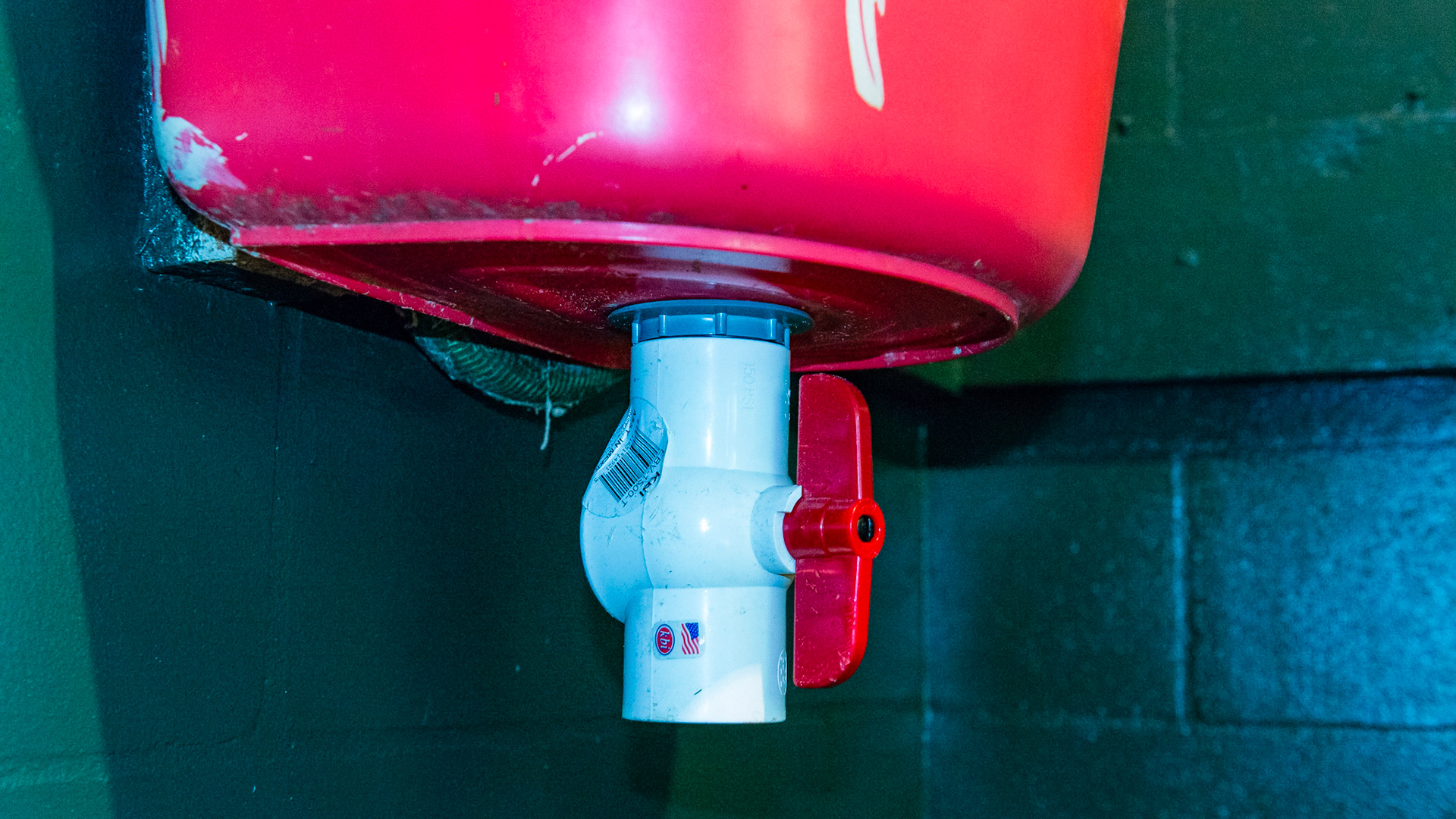 A drain has been installed in this plastic automatic water system. The owner reports that there is occasional leakage around the fitting.