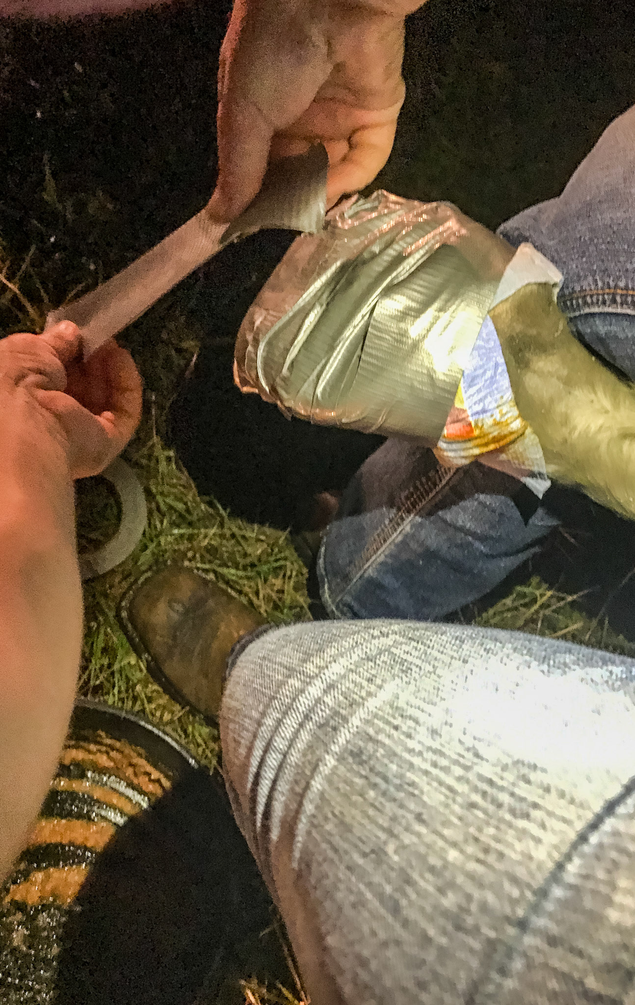 Wrapping a hoof with a diaper and duct tape.