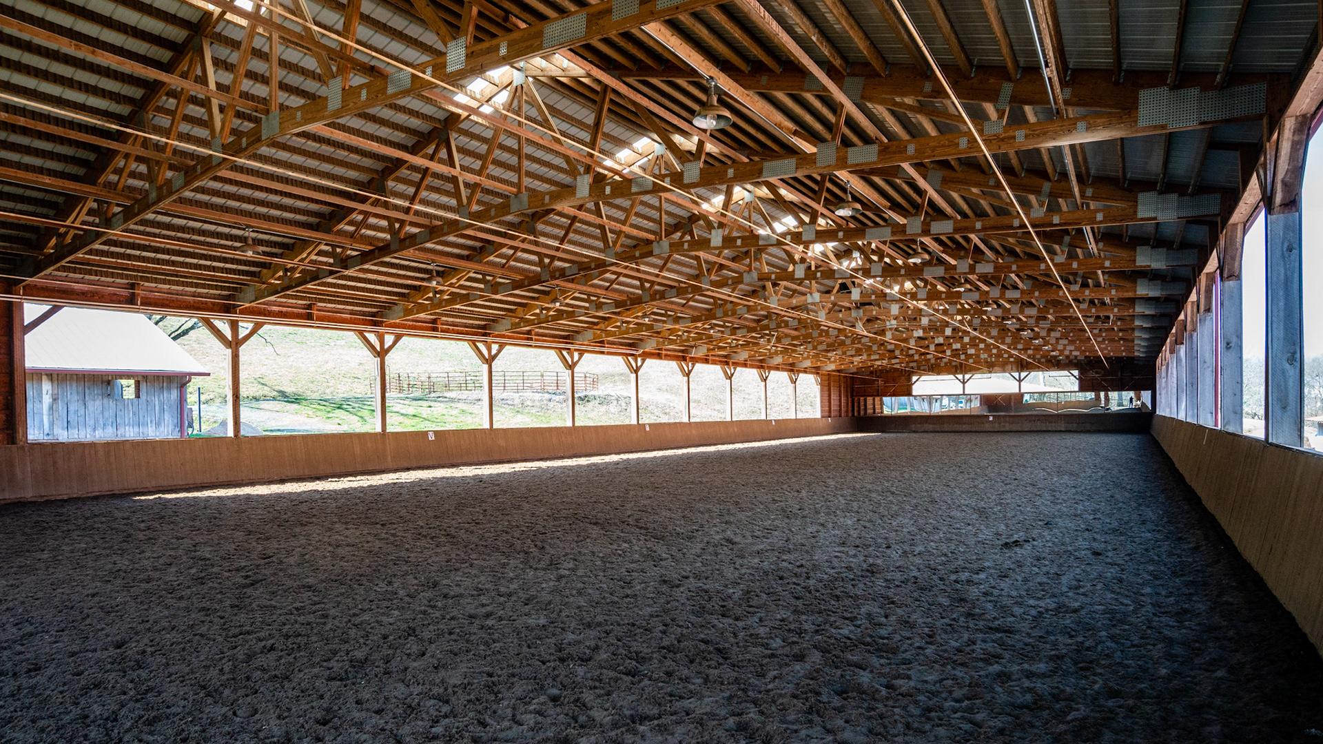 An open sided covered arena in TN. Note the arena irrigation system.