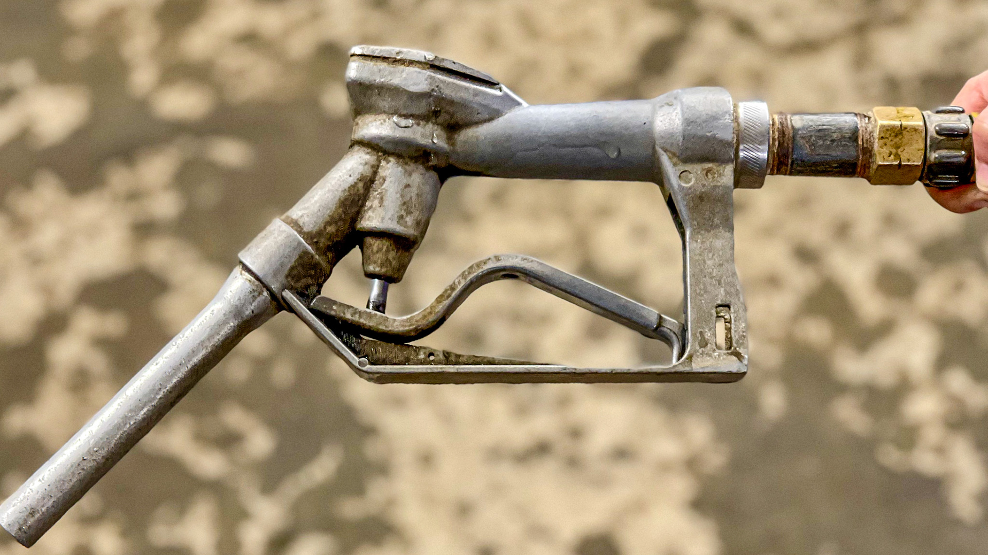 This fuel nozzle is used as a water valve to fill water buckets in this barn rapidly.