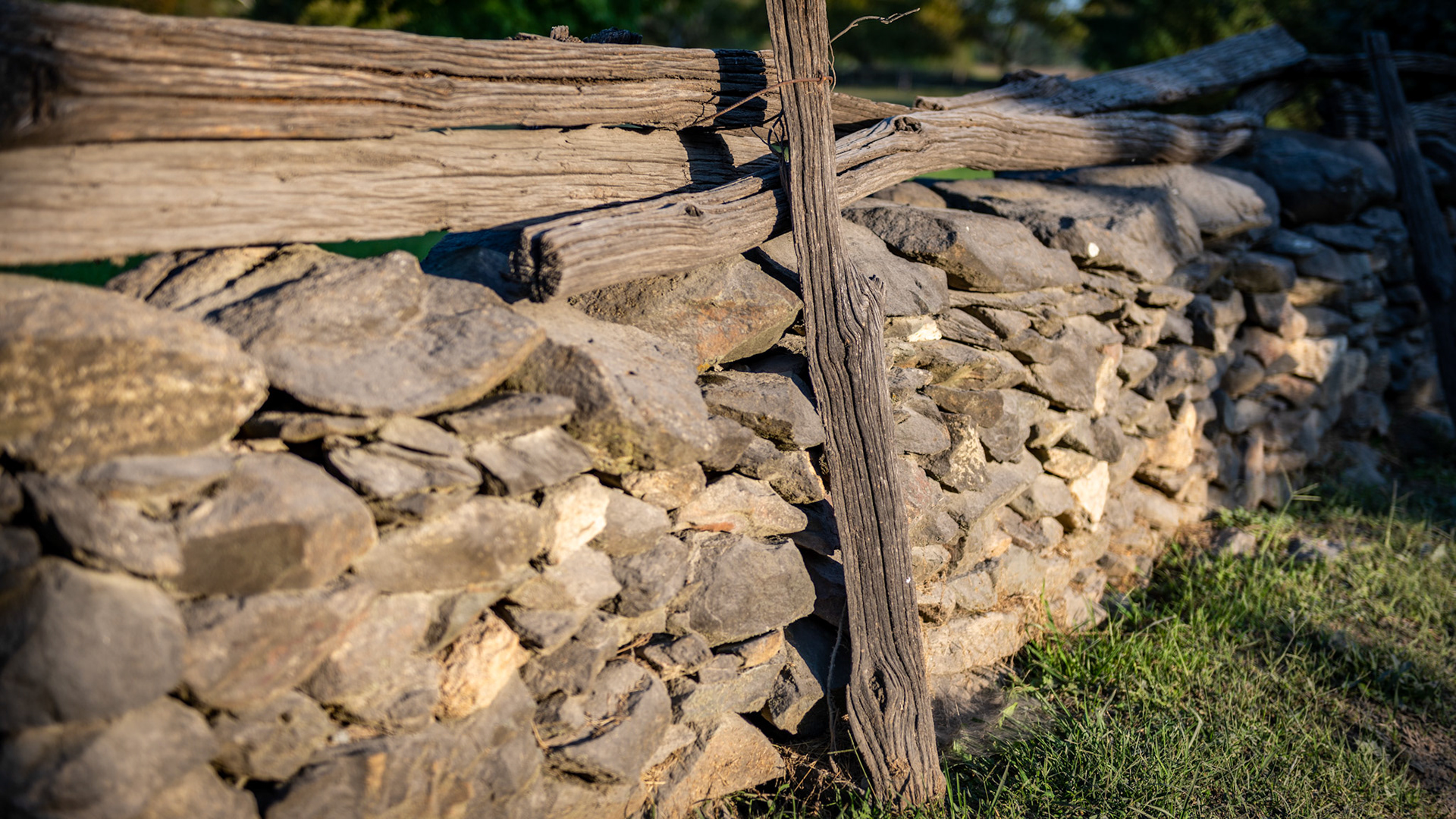 Old style stone wall with top rails.