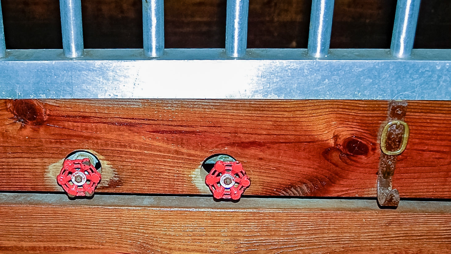 Valves outside the stall with pipes inside.