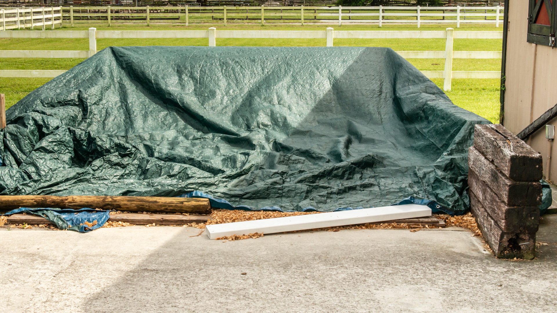 Shavings covered by a tarp.