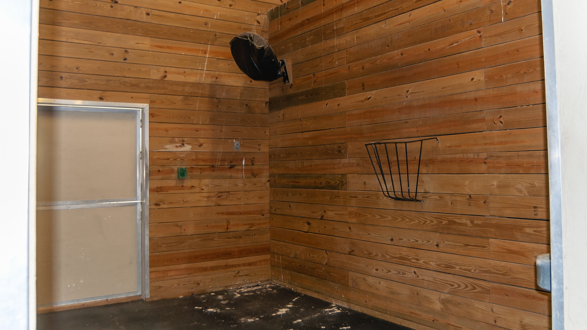 Multiple features in an abandoned horse farm being used for storage.