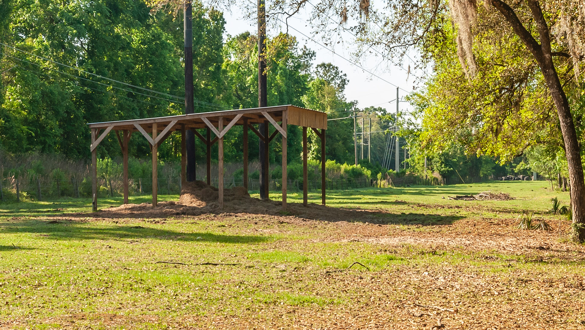 A feeding shed where a round bale is placed under in a paddock.  This offers some protection and access to a tractor for cleaning.