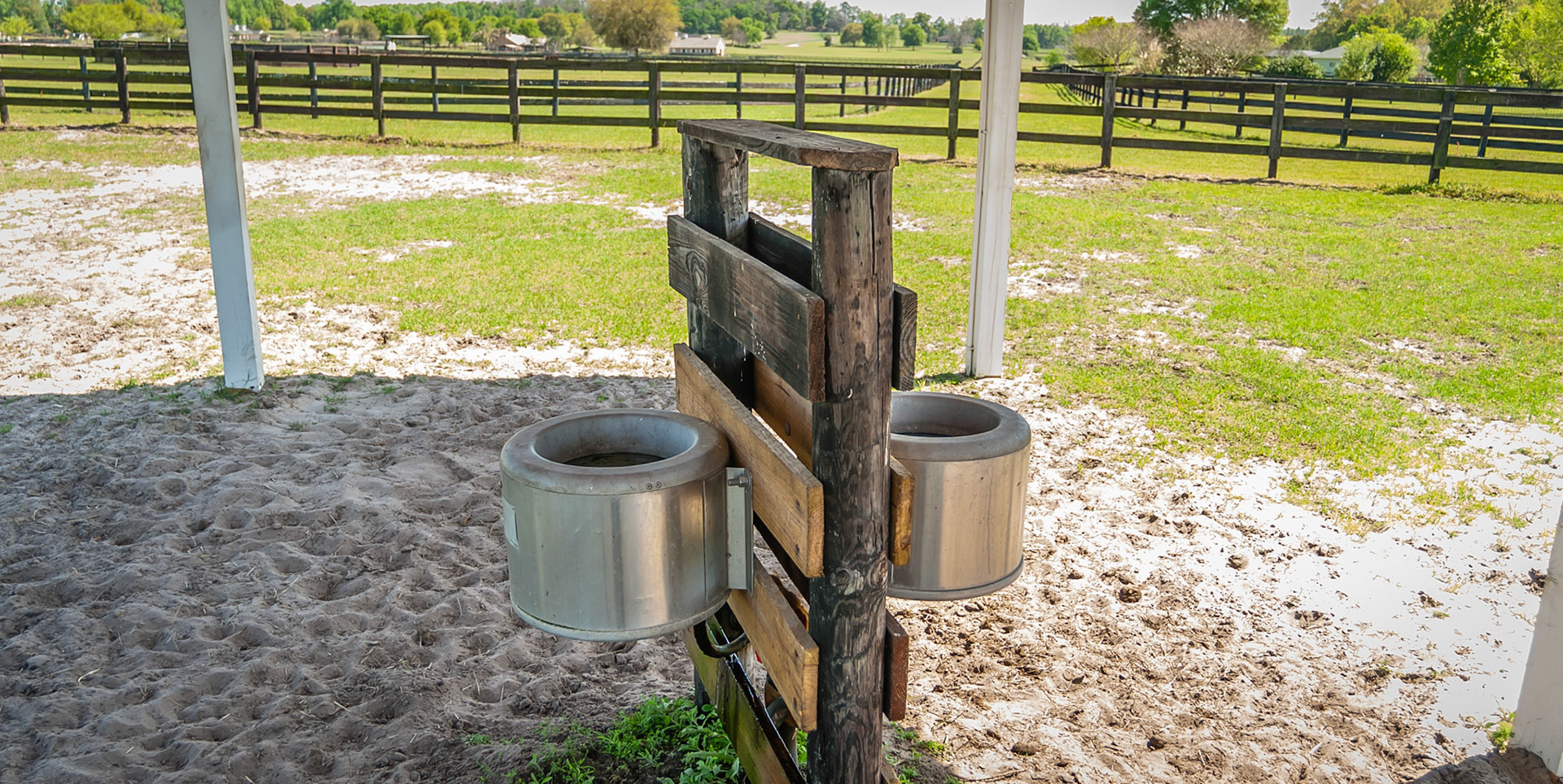 The water in the shade of the roof of this shed.