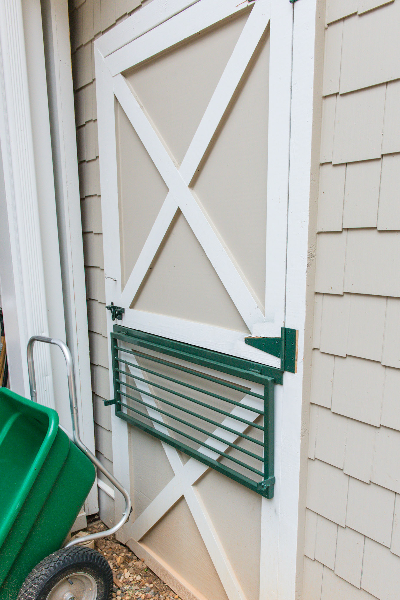 An ingenious custom made device to prevent the horse from chewing the outside of the barn while allowing his head to get outside. When the doors close for weather, part of the device lays down outside and the rest folds inside preventing the horse from chewing the closed stall door.