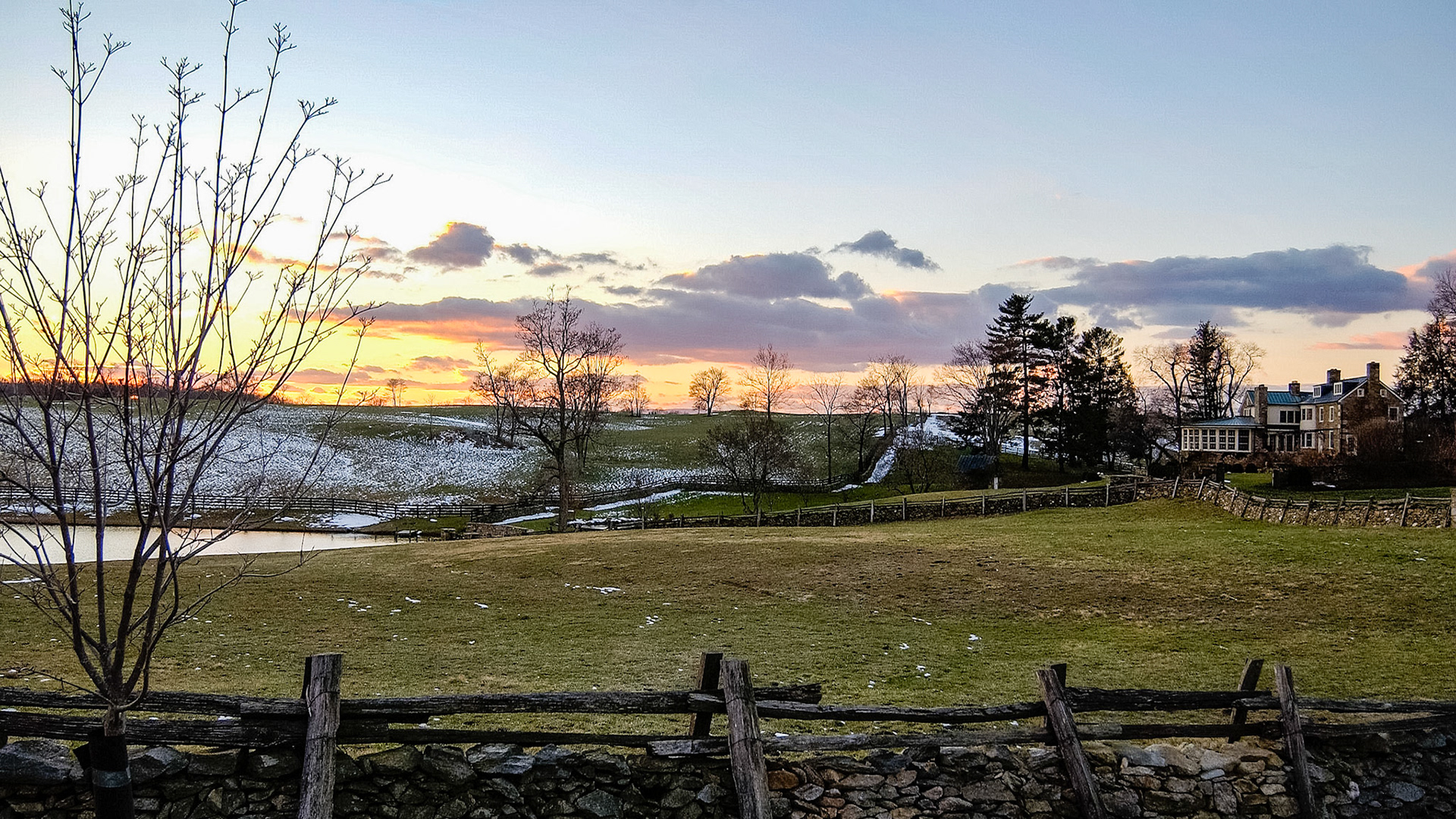 Winter dormant pasture. A traditional Virginia pasture fence made of stones with a top wooden section.