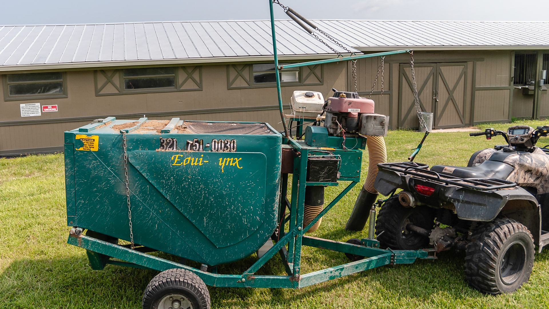 The Equi-Lynx manure vacuum pulled by an ATV.