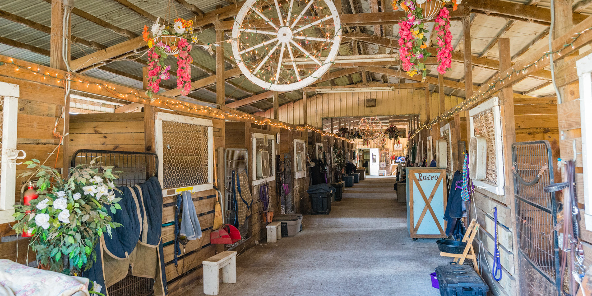 Decorating a barn. Lights, wagon wheel, and flowers.