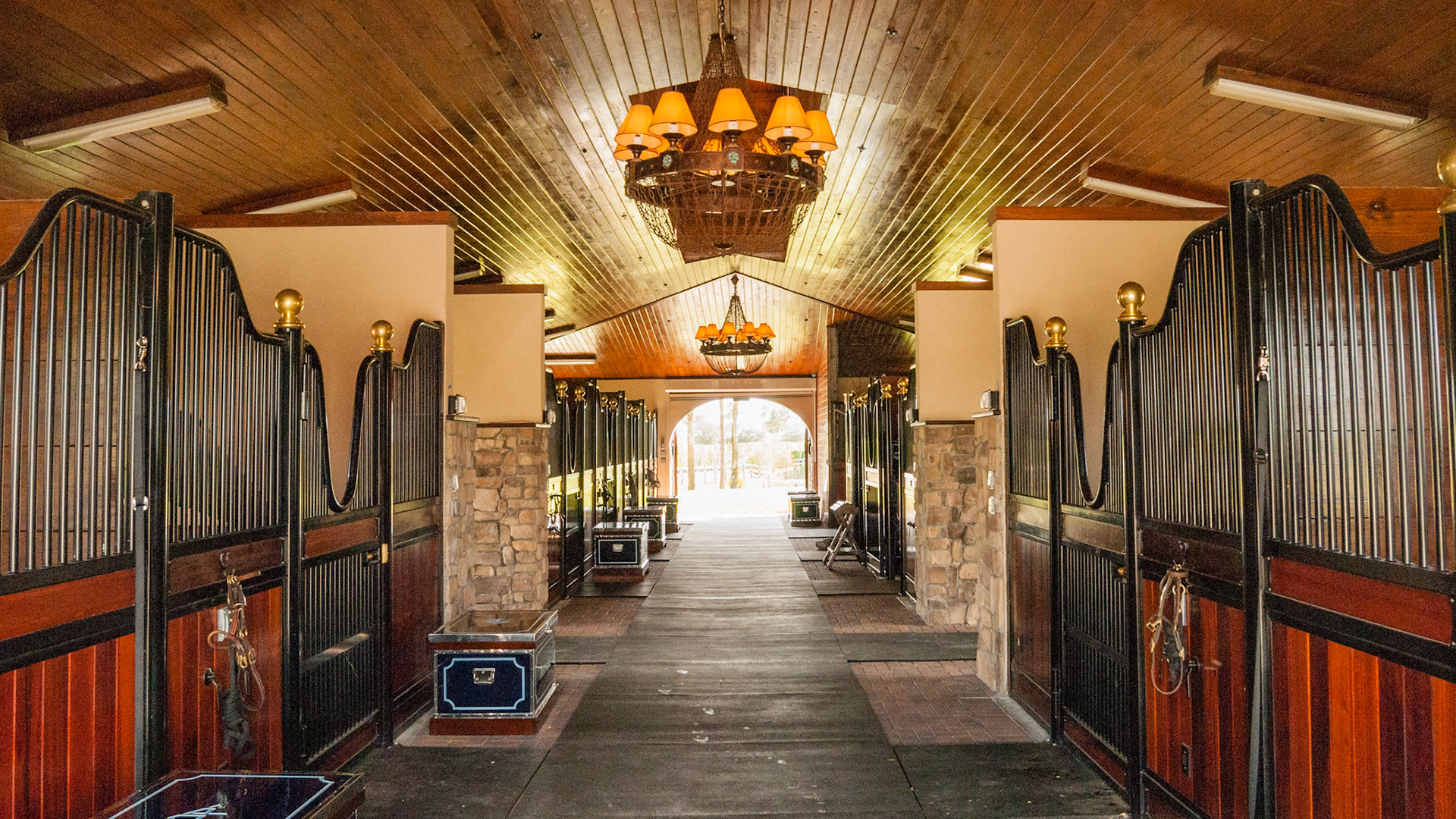 Functional fluorescent lights with additional decorative chandeliers. Also sealed and stained tongue and groove finished ceiling.