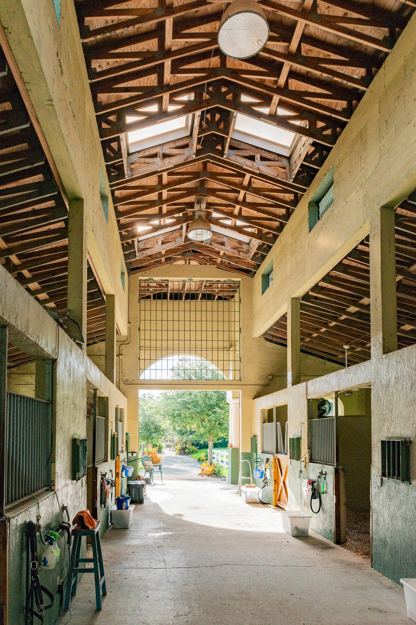 A tall center aisle roof and vents allow for good air flow.  Skylights and sodium vapor lights.