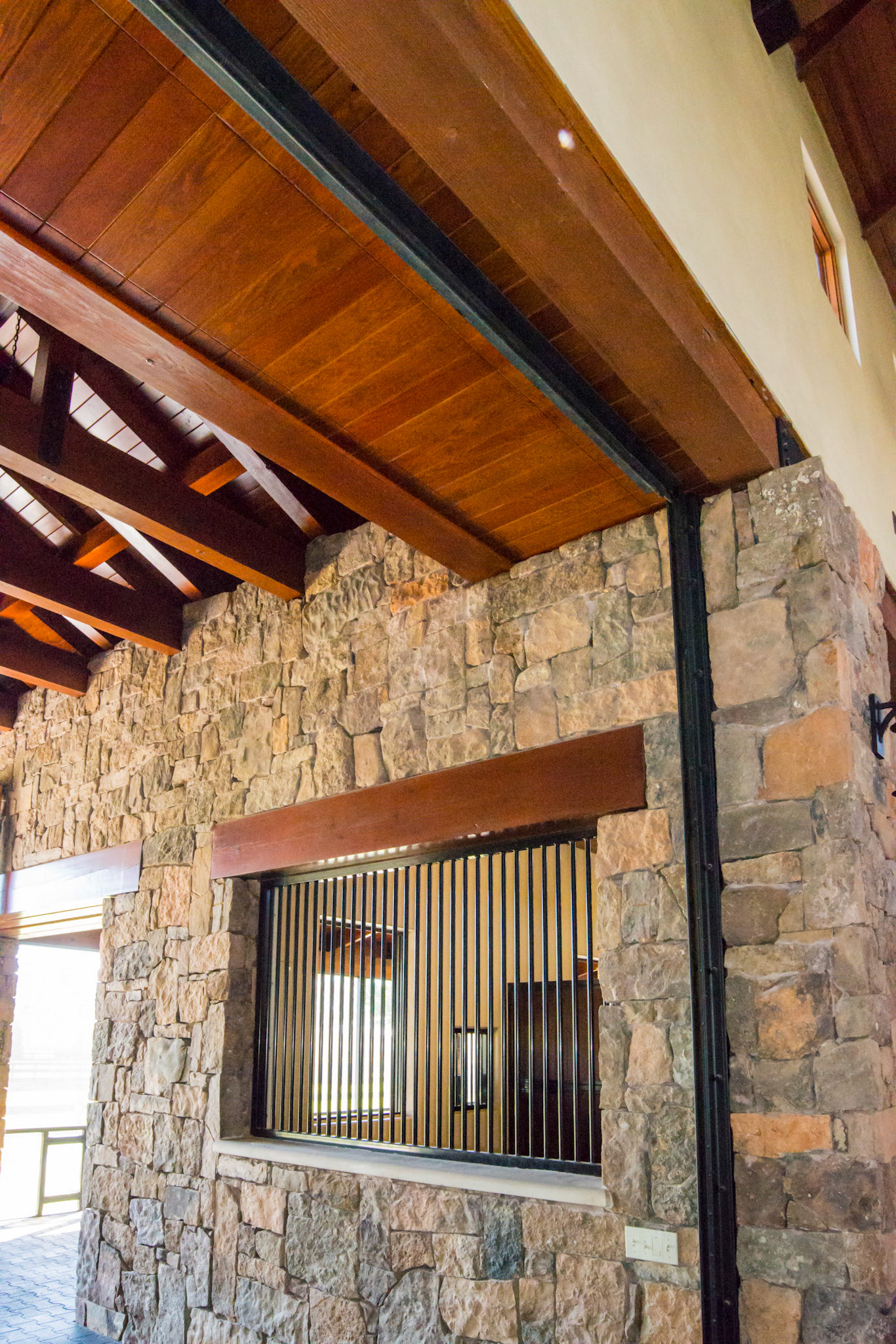 Hurricane door rolled into ceiling. Cut stone facade in imported hardwood beams and finished ceiling.