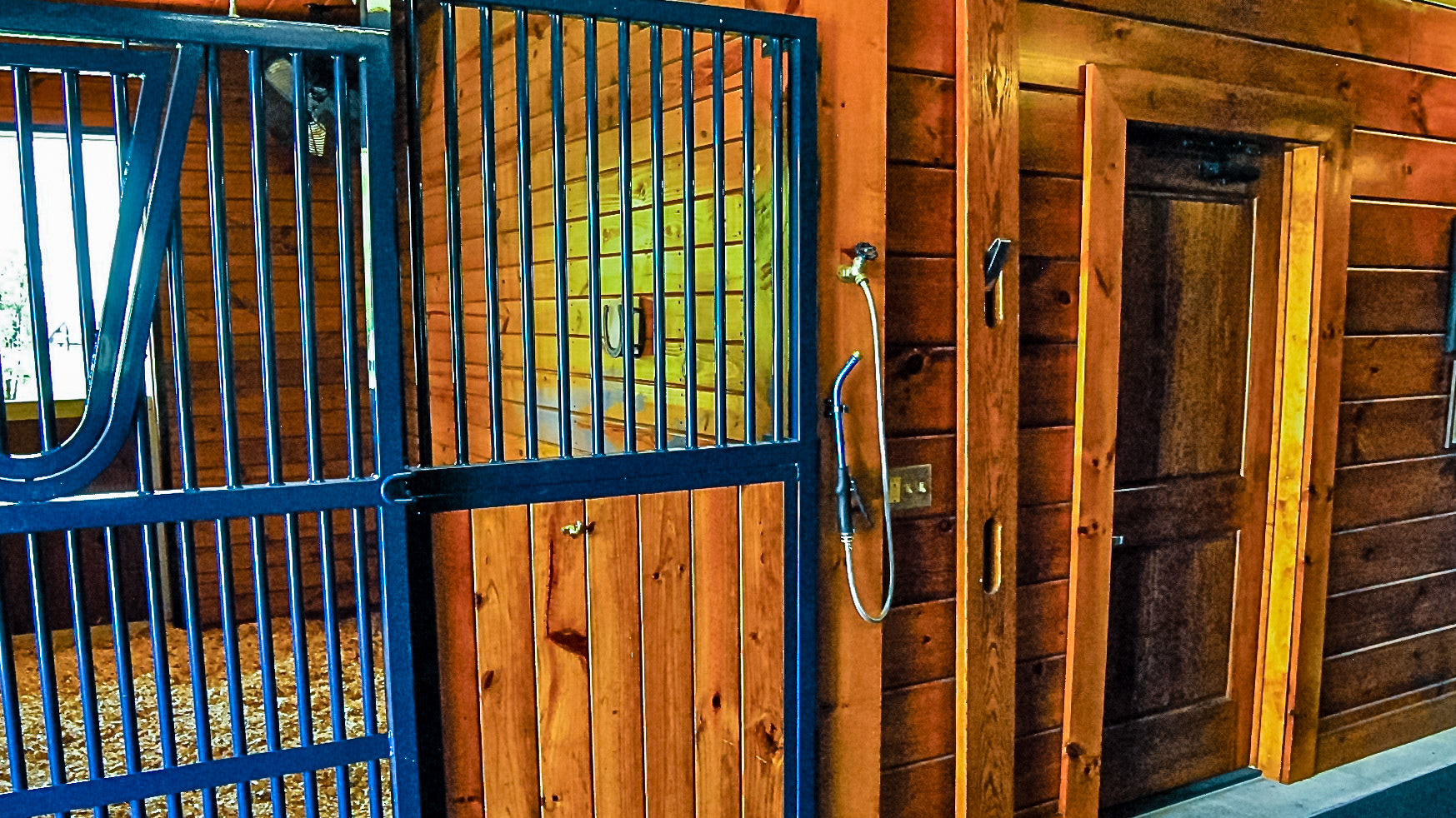 A valved feeder hose outside of a stall