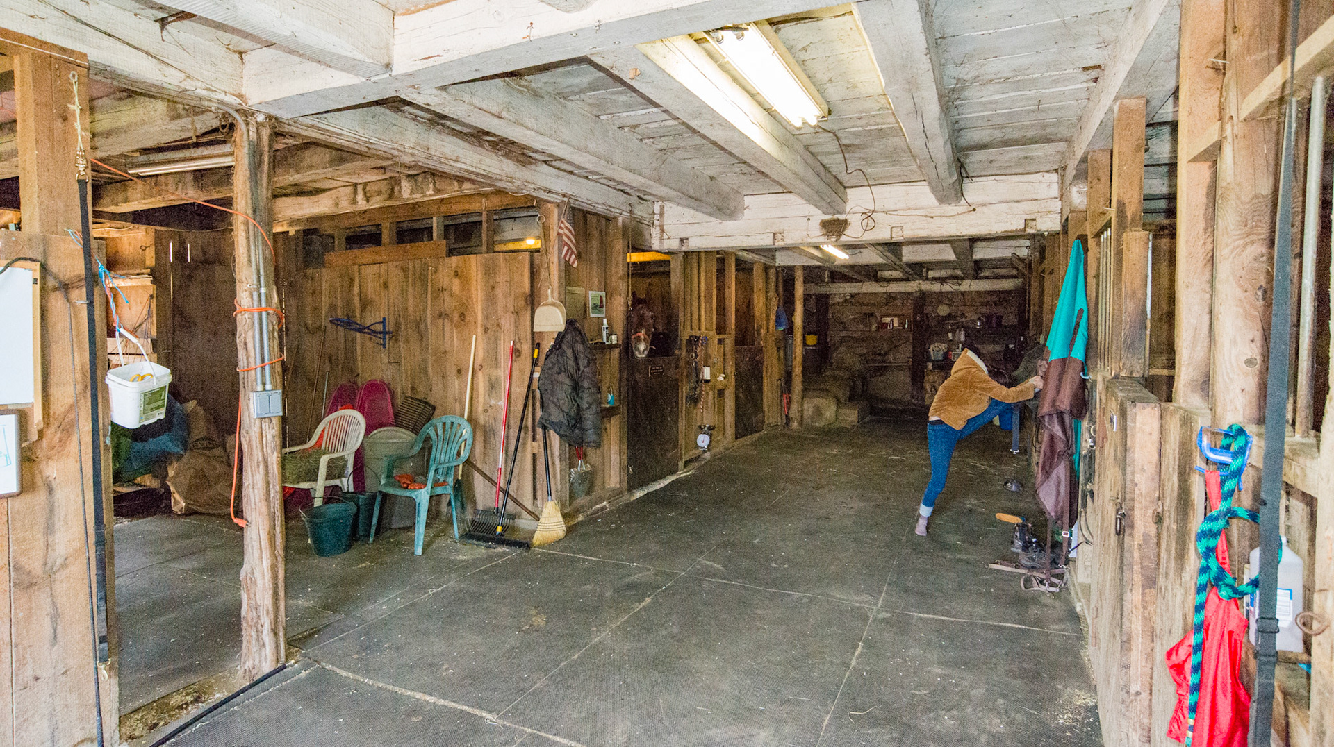 Stall interior in MA. Rubber floor mats, large ceiling beams to support hay storage above.