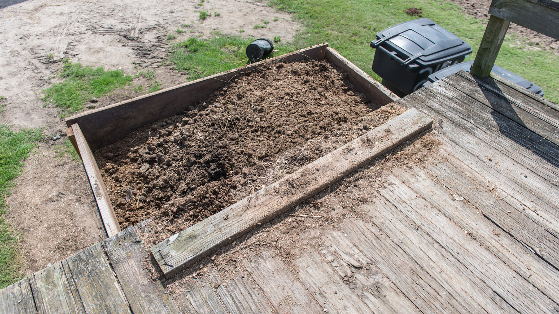 A wood block used to stop the wheel barrow on the top of the manure dumping platform.  Don't miss.