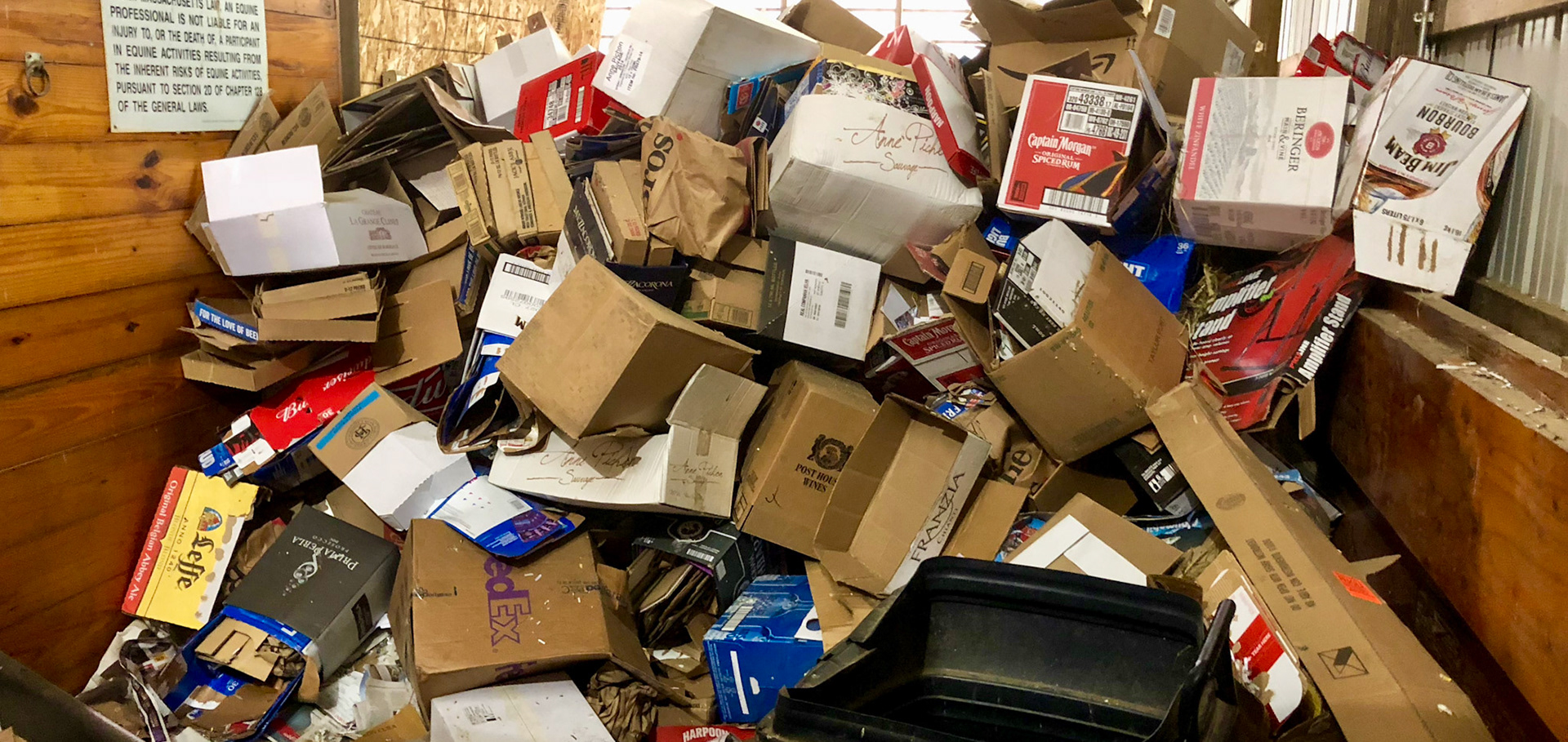 Cardboard accumulates in this stall ready for shredding into bedding. Shredding newspaper also works.