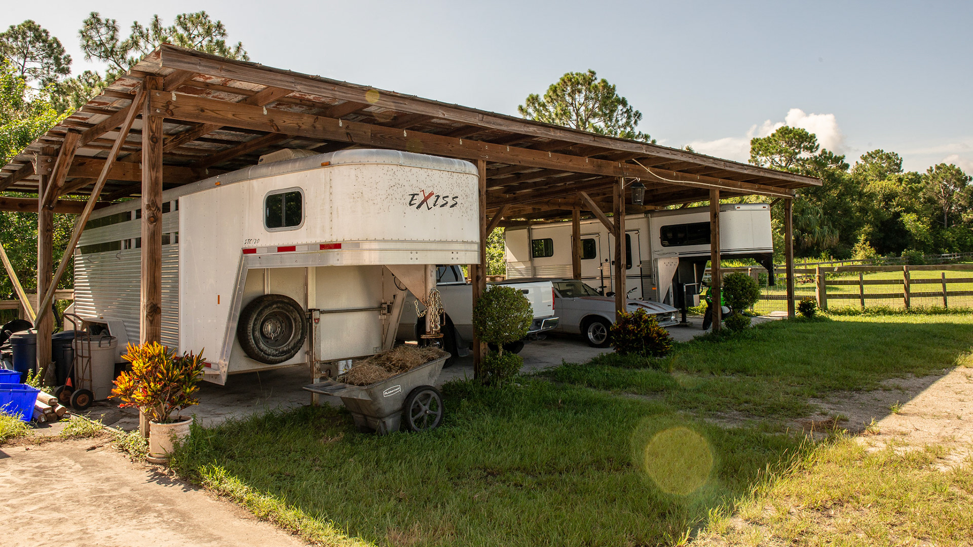 A pole barn on cement with a tin roof provides protection from the FL sun.