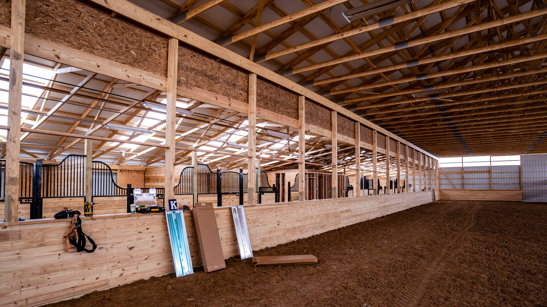 A new covered arena in CT with stalls along the length.