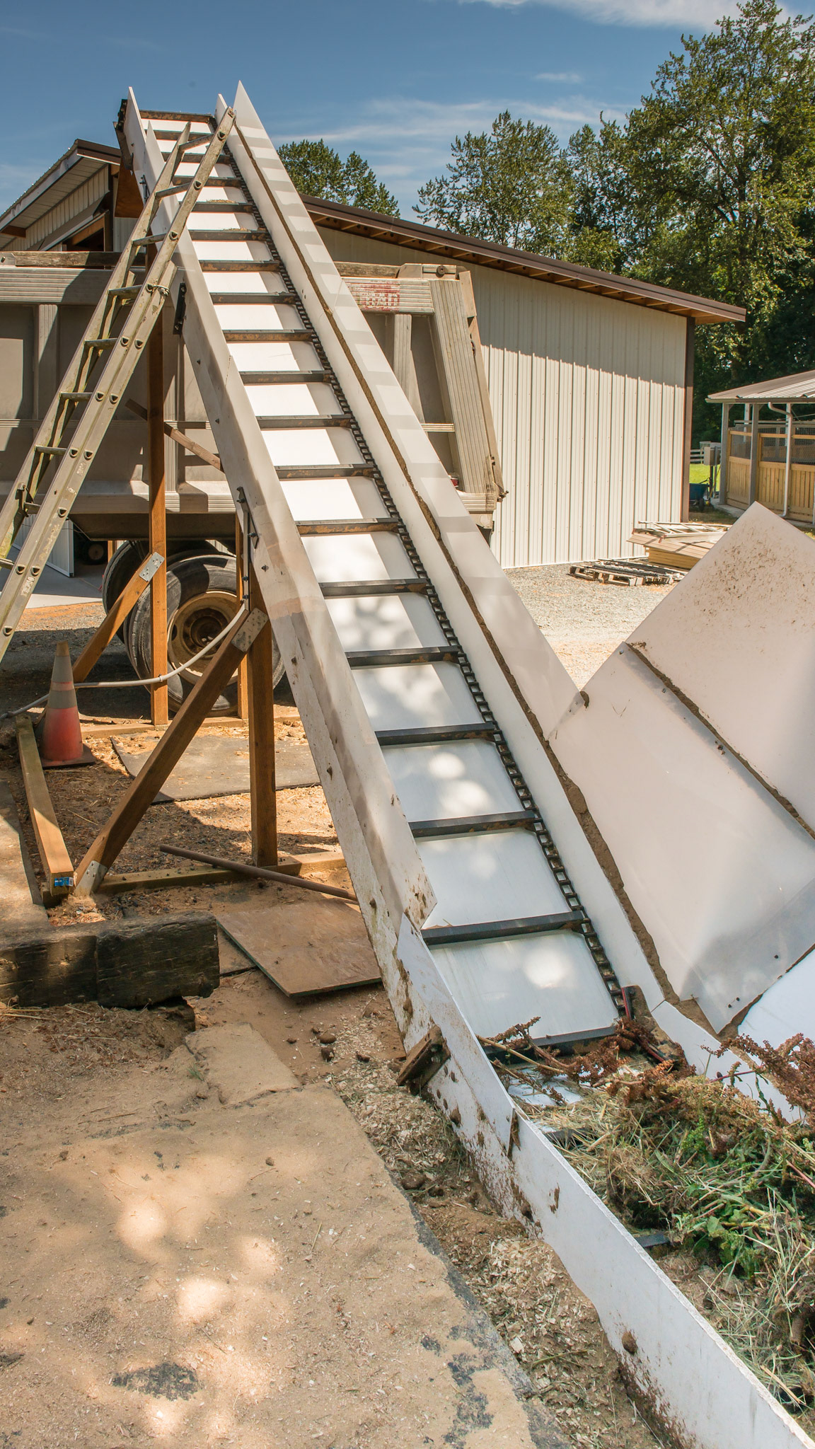 A close up of the elevator with some pine debris in the hopper.