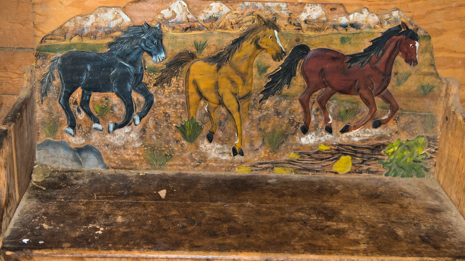 A painted bench in a barn.