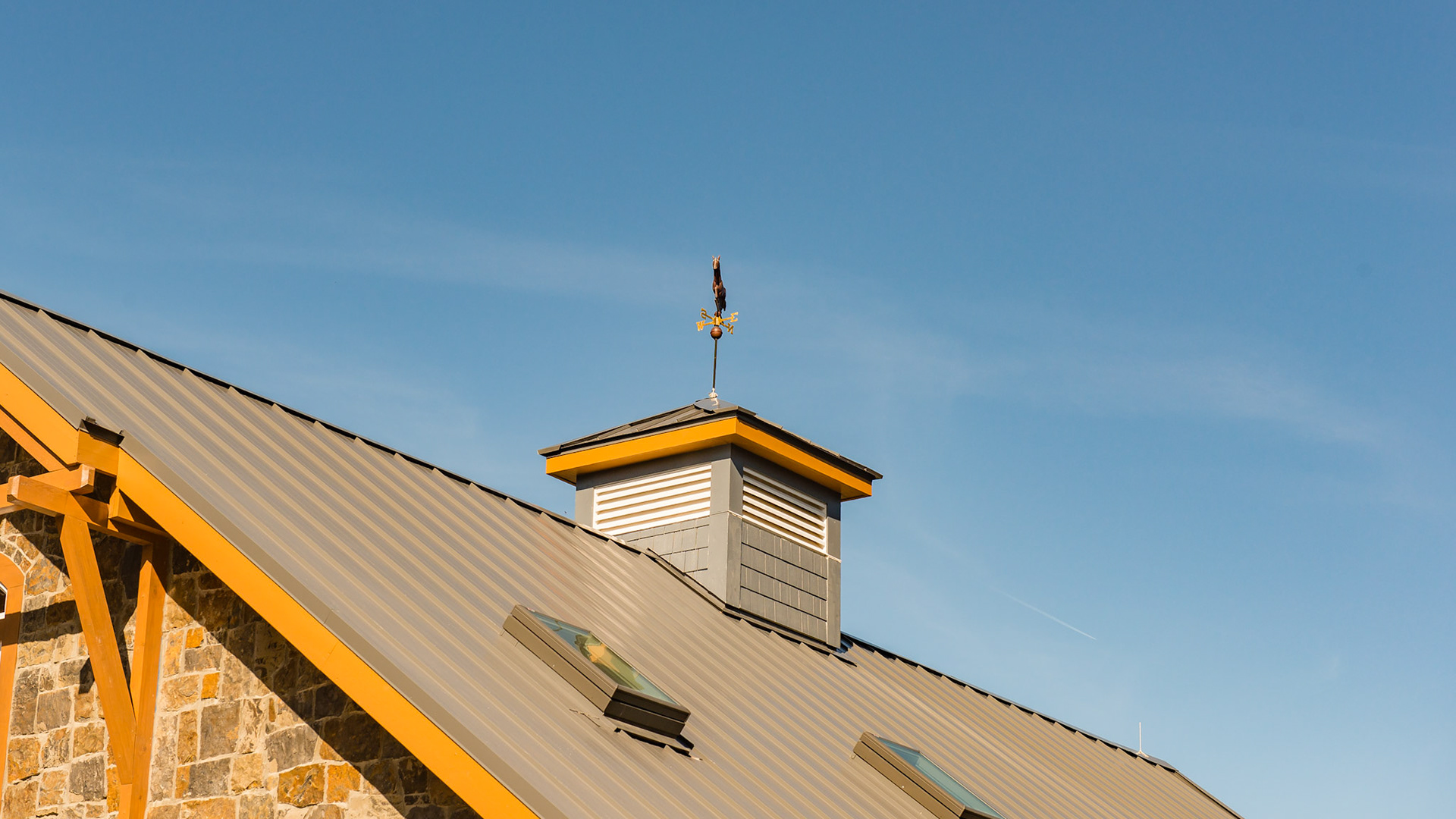A custom made cupola and opening skylights  provide functional ventilation in this barn.