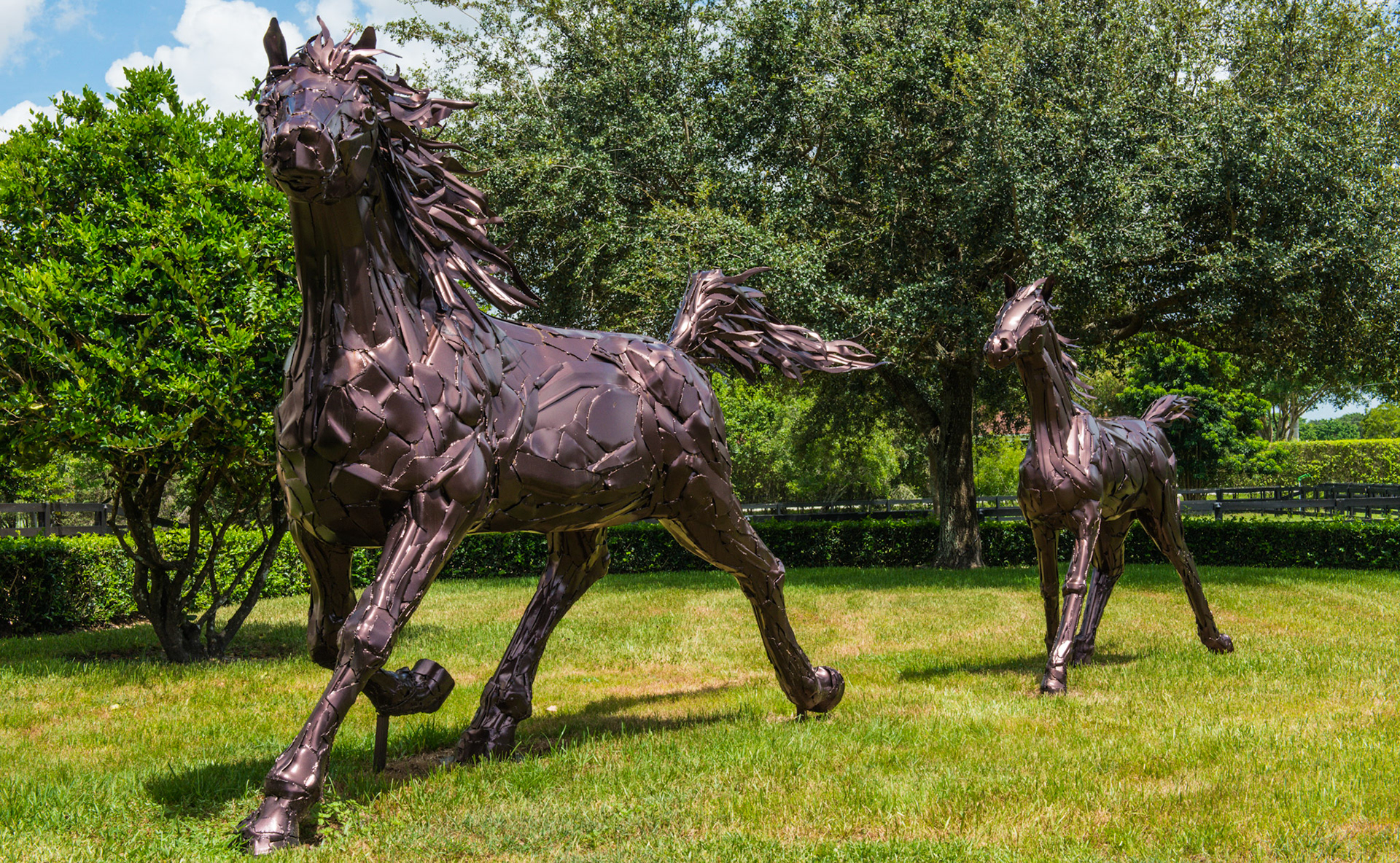 These larger than life statues are made from old chrome bumbers of cars.  The chrome had deterriorated in the Florida sun and had just been repainted in this dark color and drainage holes had been created to prevent water accumulation.
