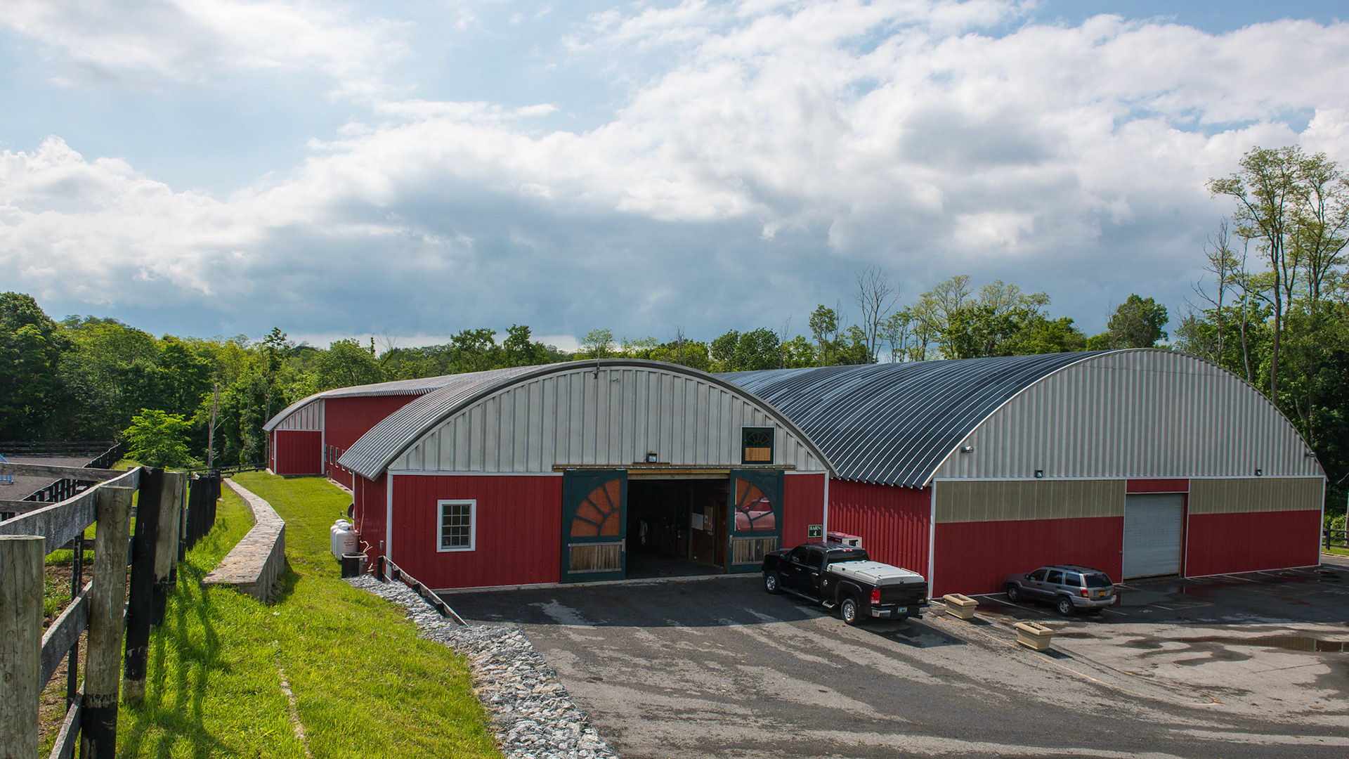 Quonset hut design for the roof of this barn and covered arena