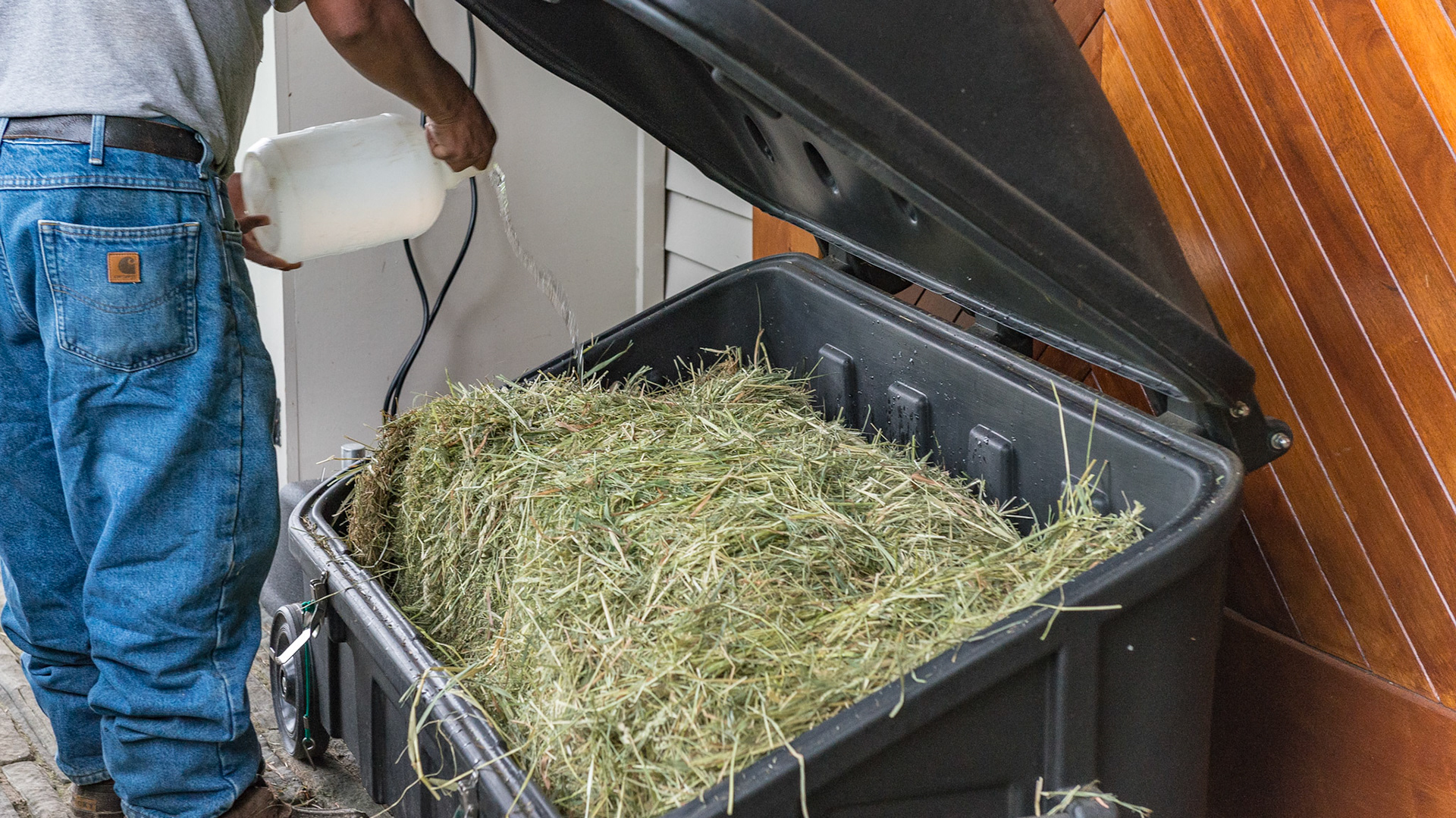 The groom adds water to the streamer before "cooking" the hay.