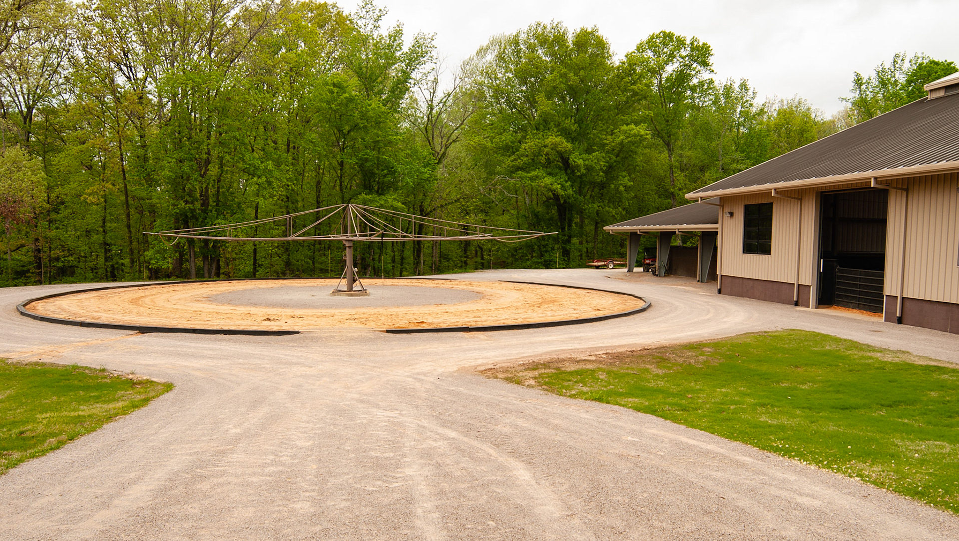Outdoor walker with no walls or fence.  These are common at race tracks when they were used years ago and called hot walkers.
