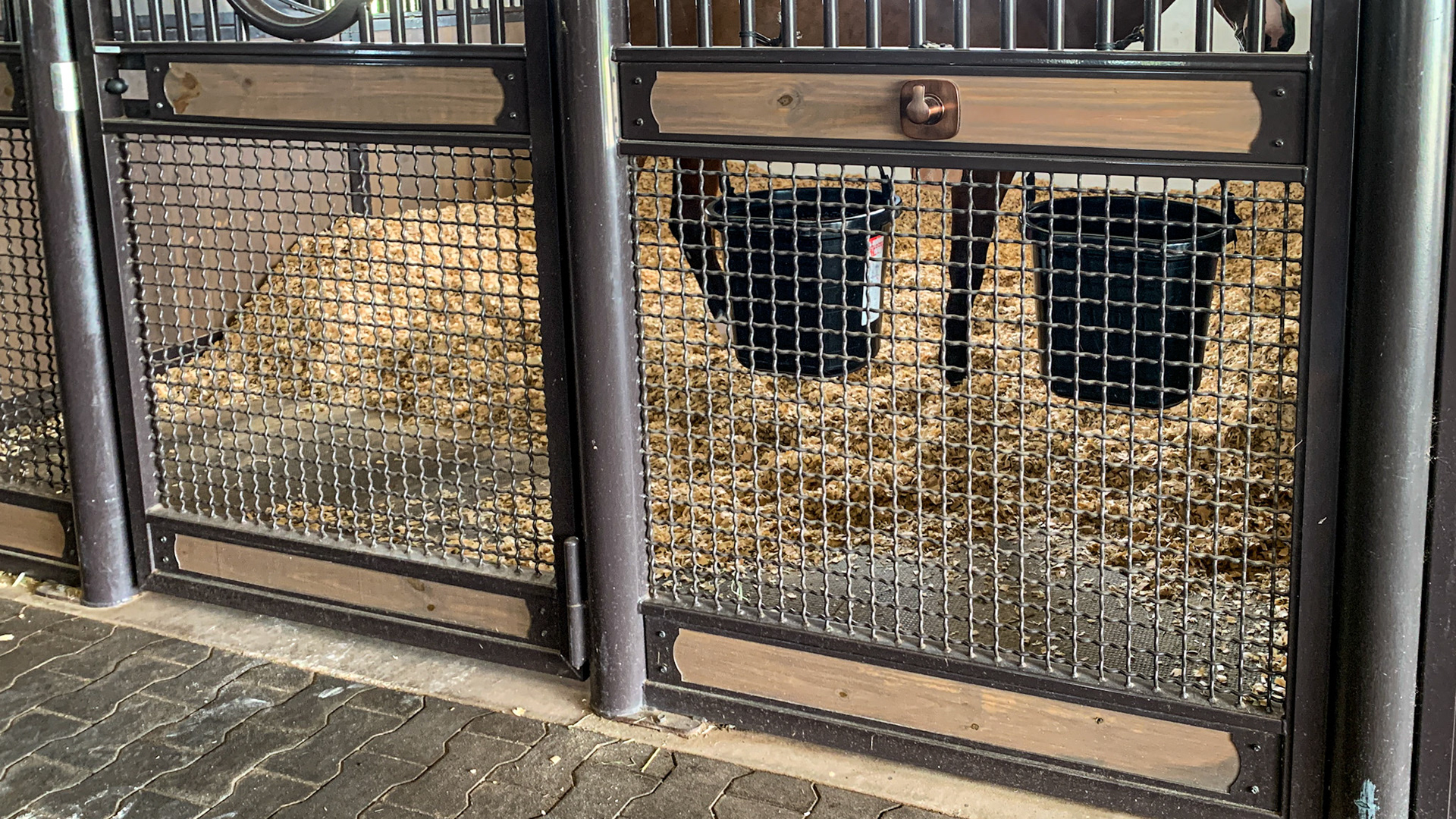 The wire mesh used for these stall walls is sturdy to withstand a kick (no dings seen anywhere) yet allows for free air flow in south Florida.