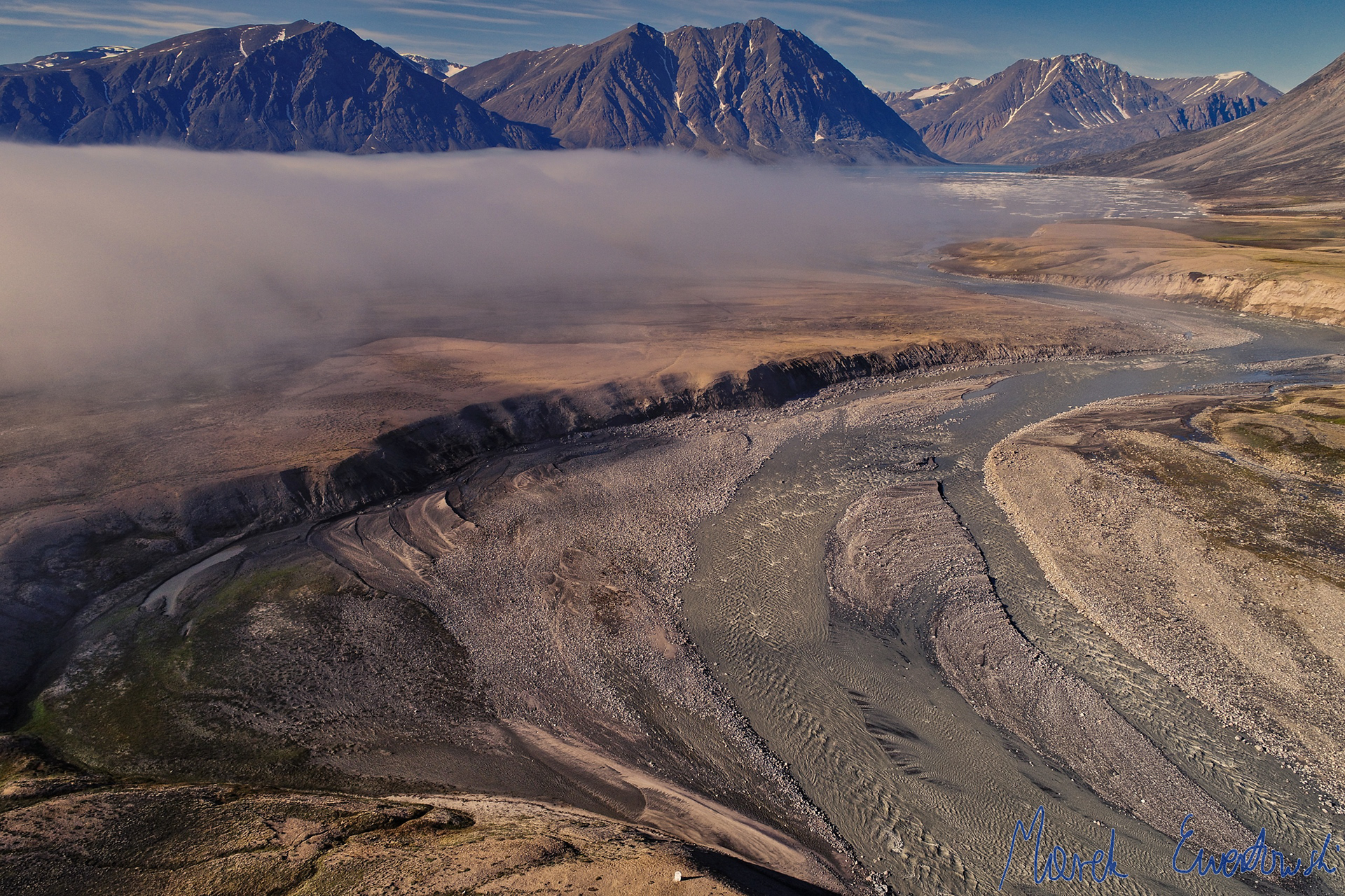 Advection fog caused by cold air advancing from the cool sea toward the warm land. Zackenberg River, Greenland. 