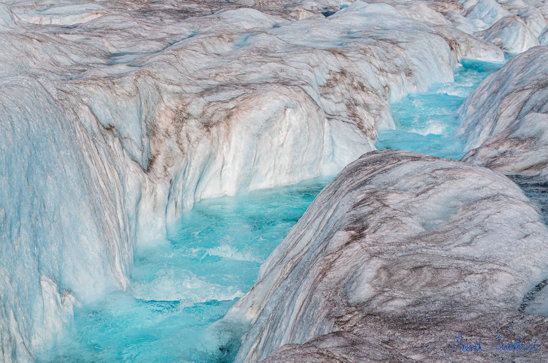 Why does a white ice melt into blue water?