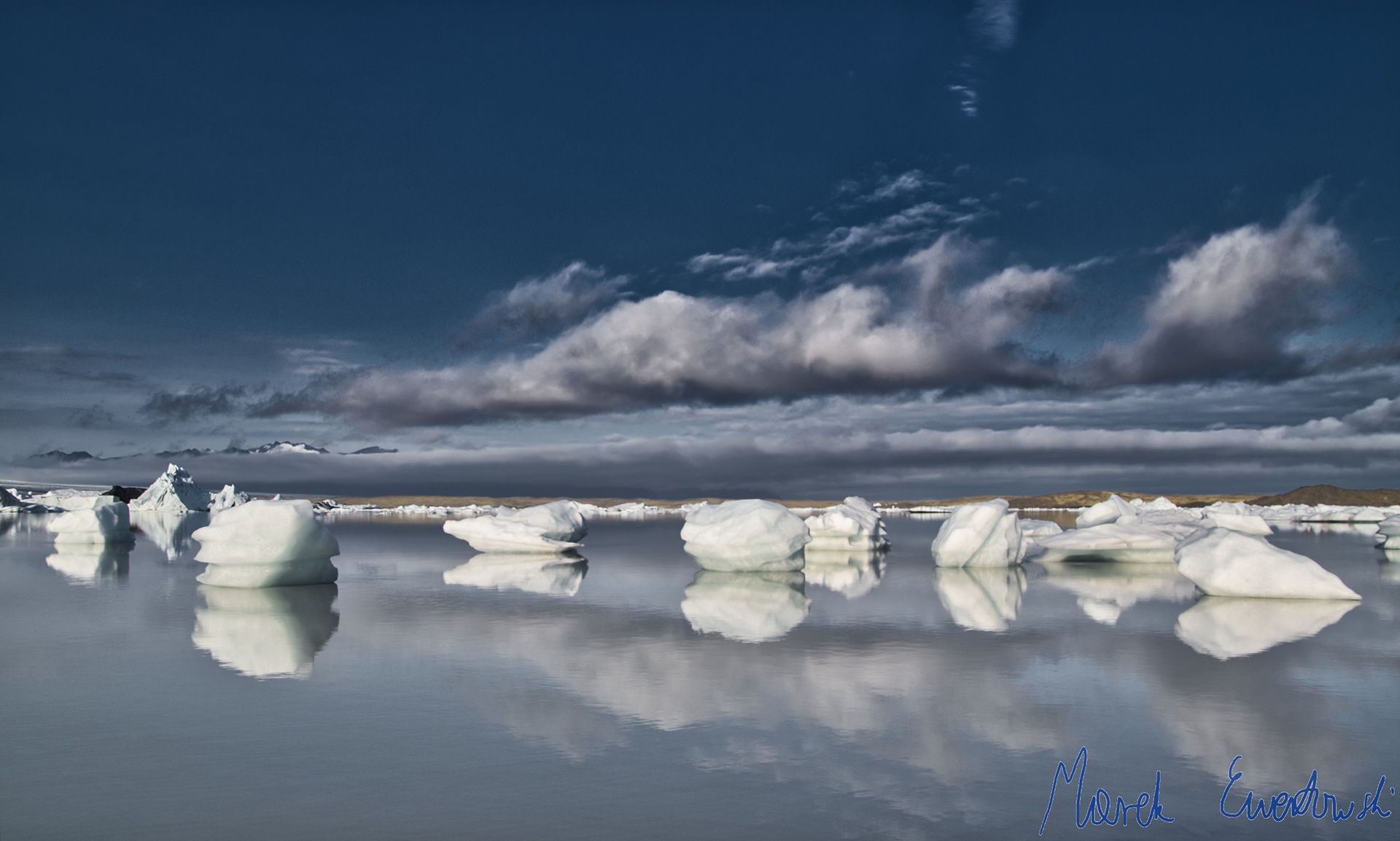Iceland is famous for its strong winds and rapidly changing weather conditions. Seeing the surface of glacial lagoon Fjallsárlón smooth as a mirror was one of the most stunning views after several days of heavy storms. Fjallsárlón, Iceland.