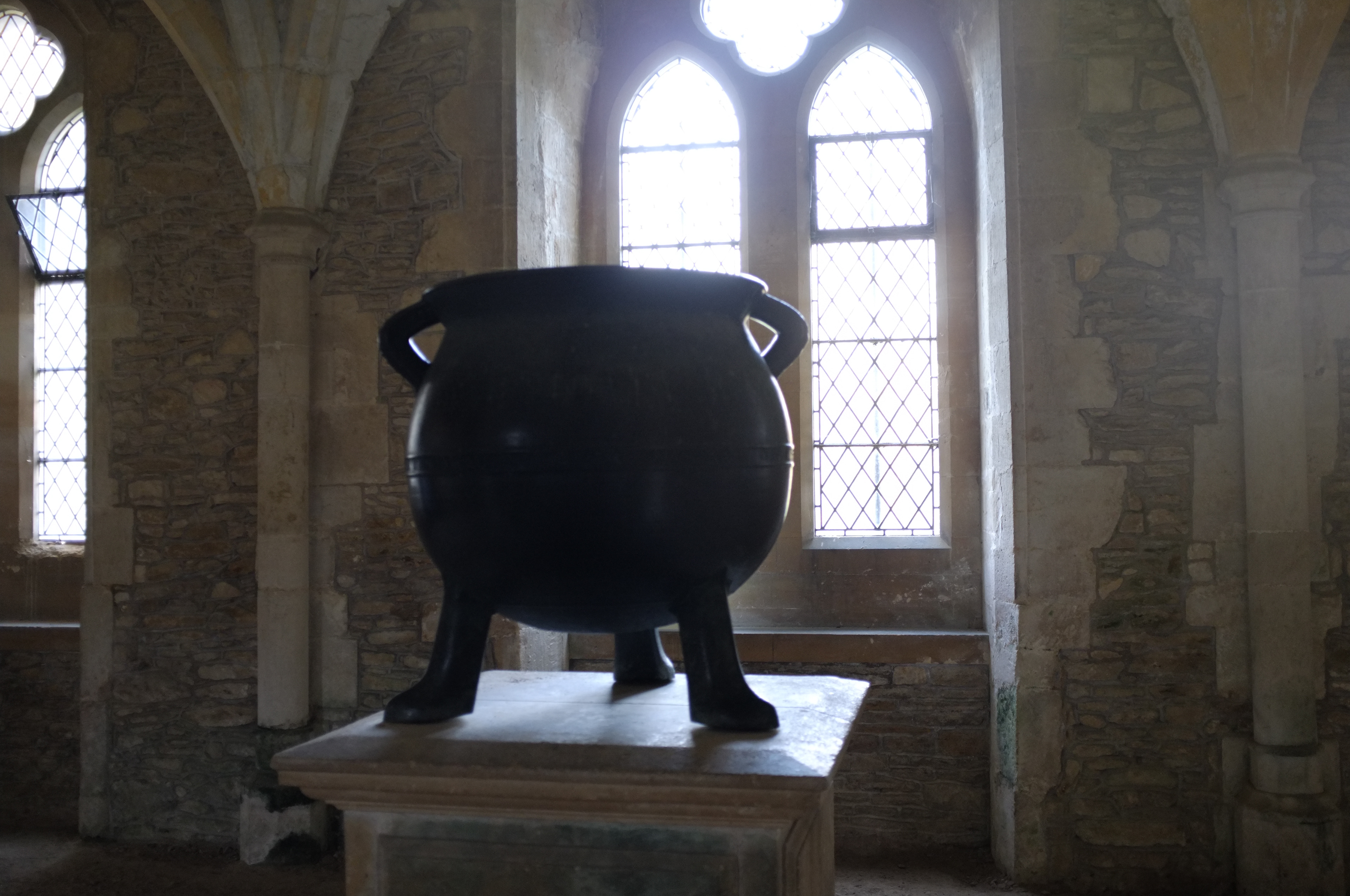 urn inside Lacock Abbey, photographed against the light coming in through a large window
